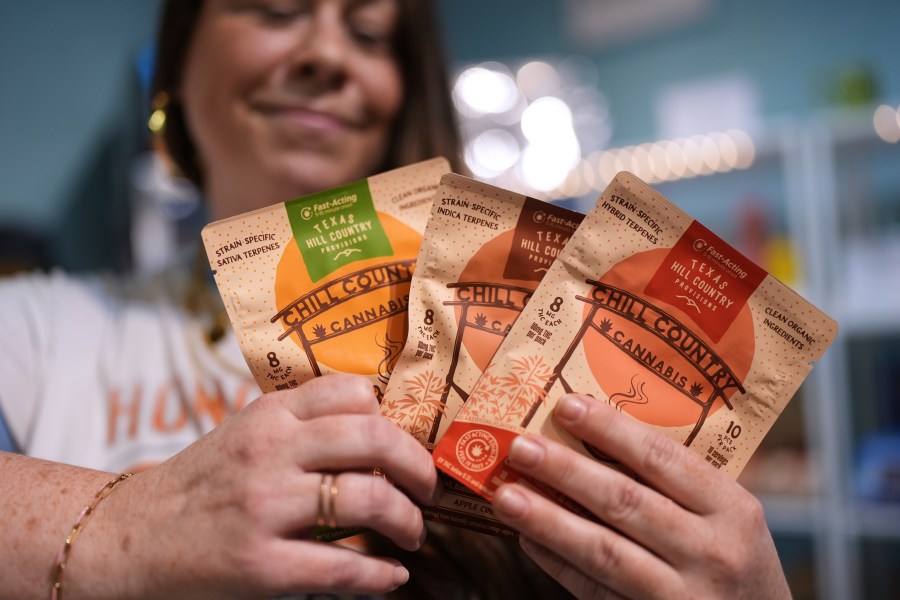 Employee Savannah Gavlik displays THC products at the Dope Daughters dispensary that Texas lawmakers are seeking to ban, Thursday, May 29, 2025, in Austin, Texas. (AP Photo/Eric Gay)