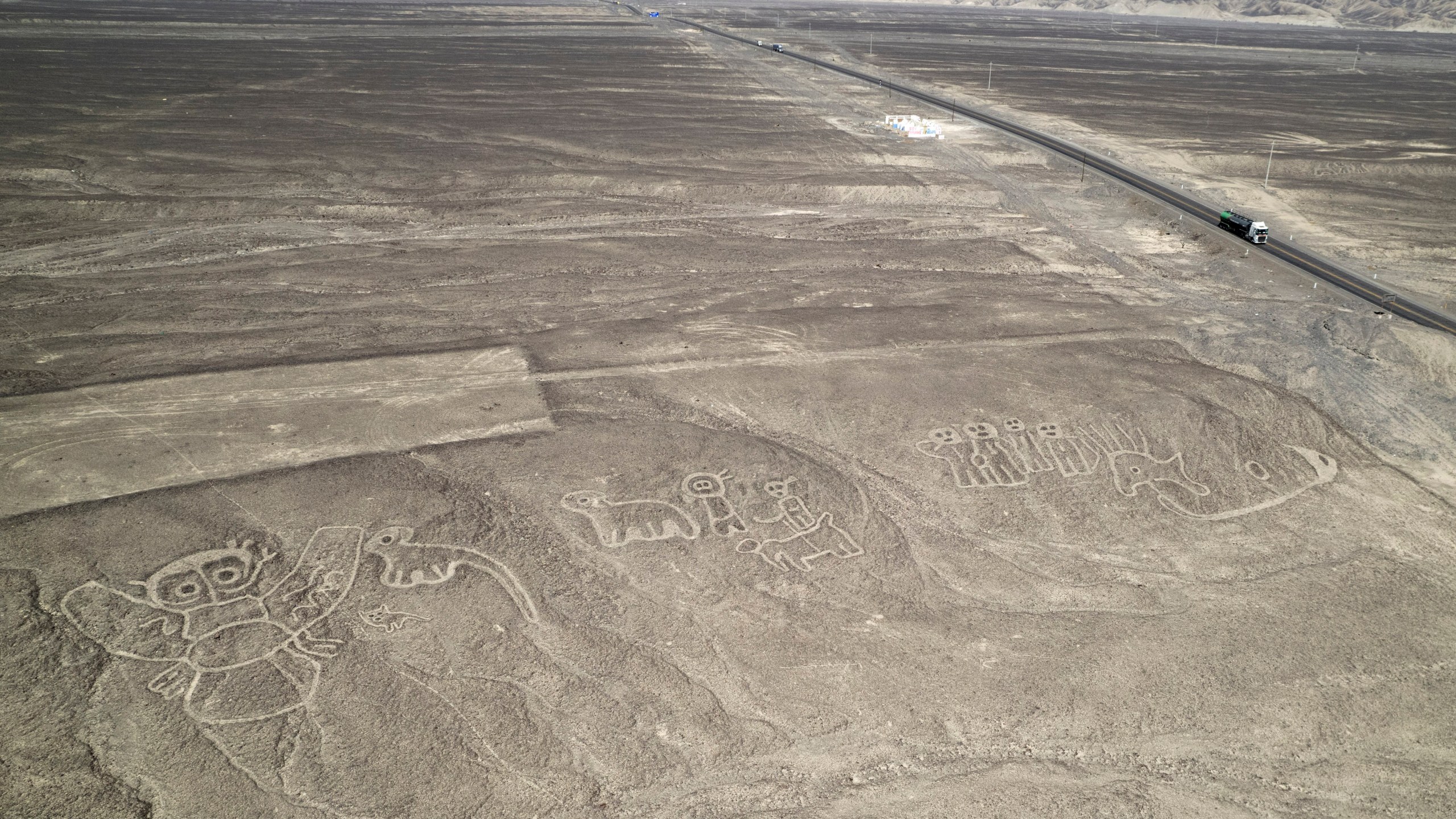 FILE - Geoglyphs known as the Nazca Lines are visible next to the Pan American Highway in La Pampa de Nazca, Peru, May 17, 2023. (AP Photo/Martin Mejia, File)
