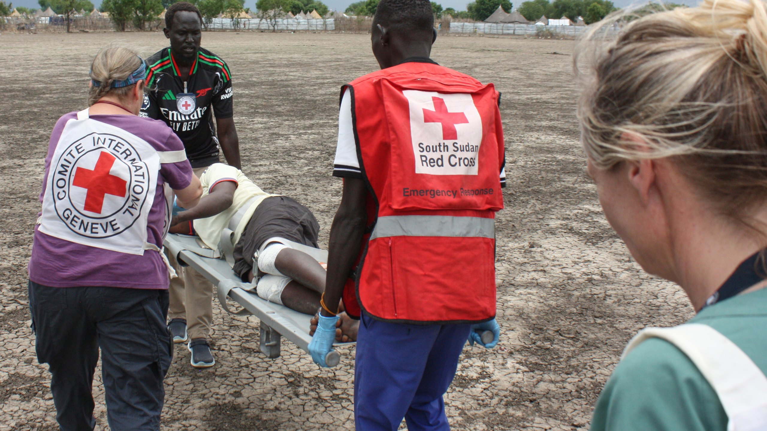 Medical staff with the International Committee of the Red Cross (ICRC) and South Sudan Red Cross carry a weapon-wounded patient in Akobo, South Sudan, Saturday, May 24, 2025. (AP Photo/Joseph Falzetta)