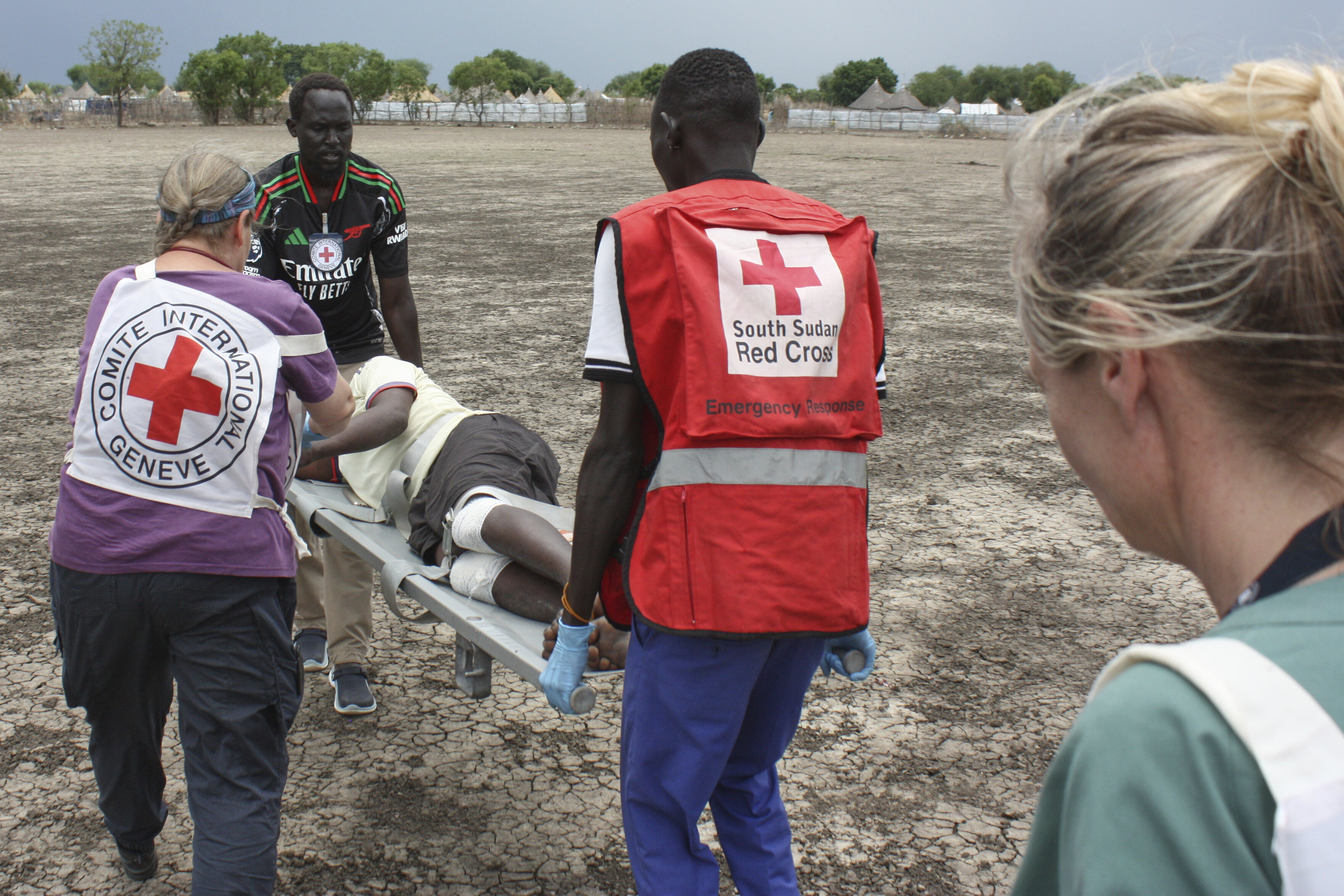 Medical staff with the International Committee of the Red Cross (ICRC) and South Sudan Red Cross carry a weapon-wounded patient in Akobo, South Sudan, Saturday, May 24, 2025. (AP Photo/Joseph Falzetta)