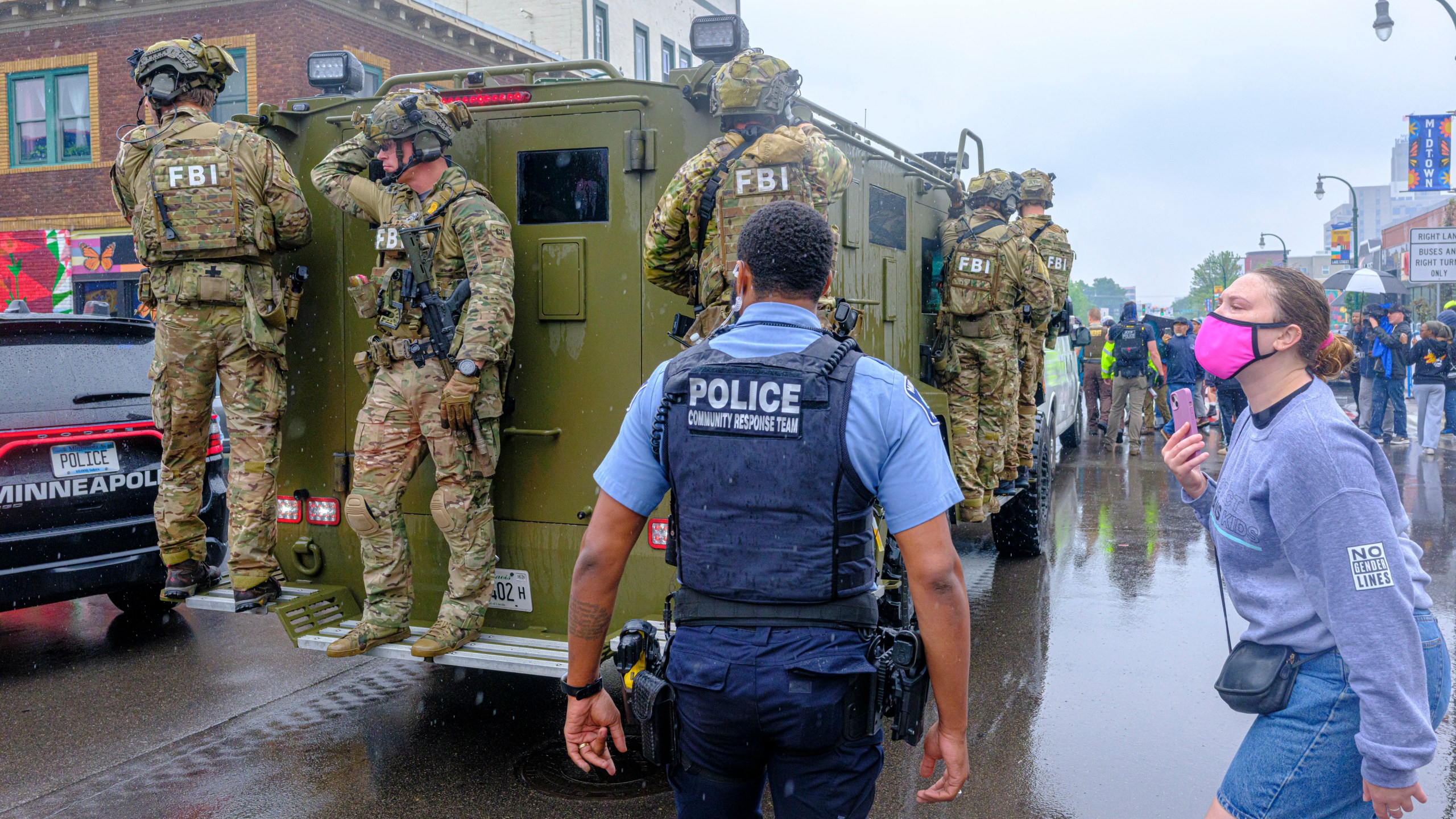 FBI officers stand on an armored vehicle as demonstrators gather in Minneapolis on Tuesday, June 3, 2025, after multiple law enforcement officers entered a restaurant in a Hispanic neighborhood, escalating tensions in the community. (Kerem Yucel/Minnesota Public Radio via AP)