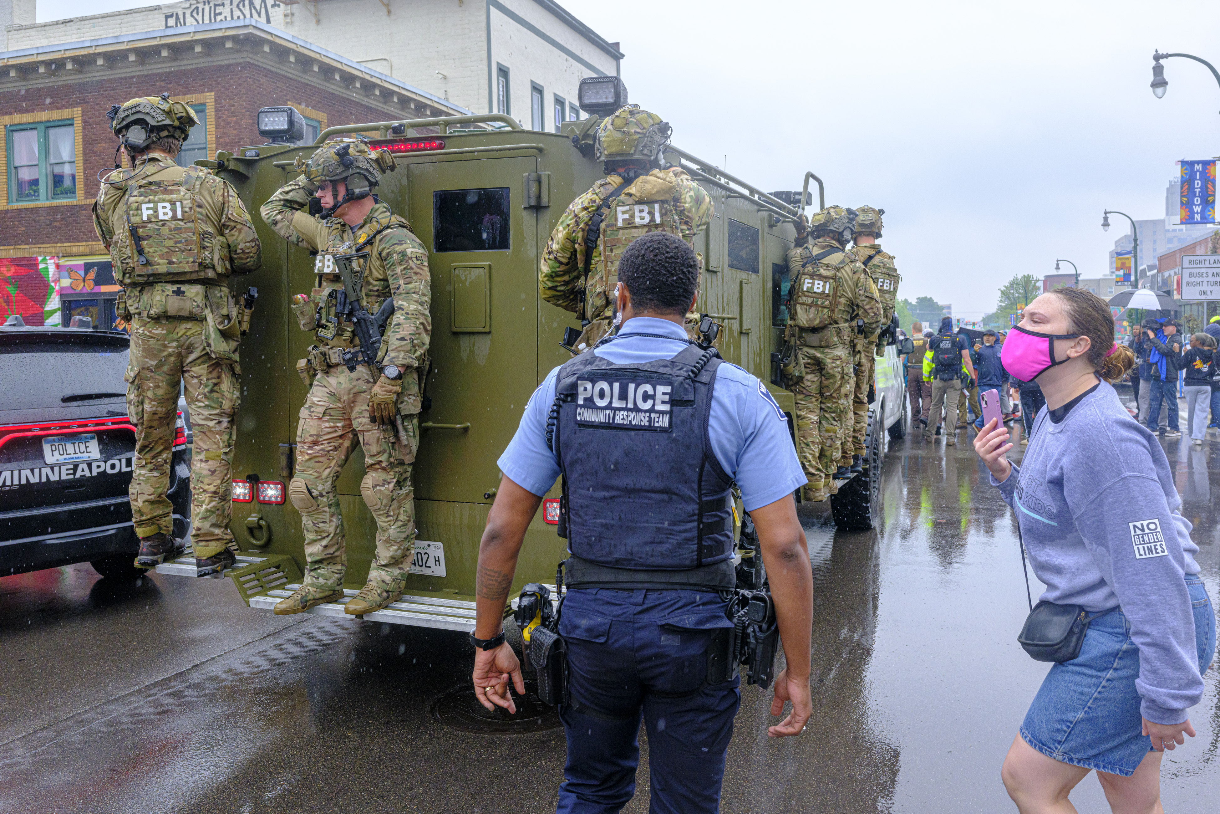 FBI officers stand on an armored vehicle as demonstrators gather in Minneapolis on Tuesday, June 3, 2025, after multiple law enforcement officers entered a restaurant in a Hispanic neighborhood, escalating tensions in the community. (Kerem Yucel/Minnesota Public Radio via AP)