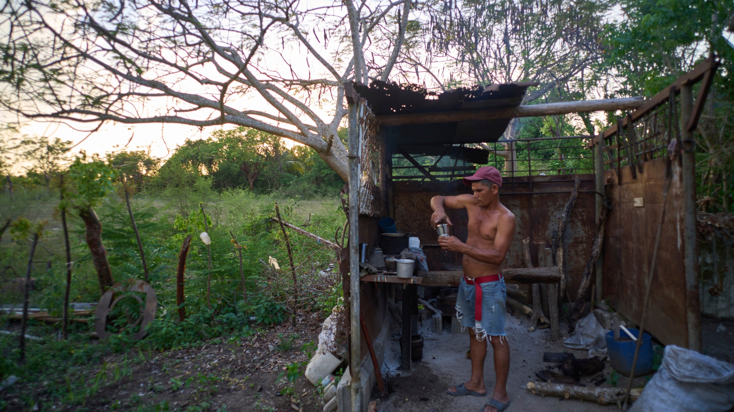 Edinector Vazquez prepares coffee on a charcoal stove behind his home during a blackout in Minas, Havana province, Cuba, Monday, May 26, 2025. (AP Photo/Ramon Espinosa)