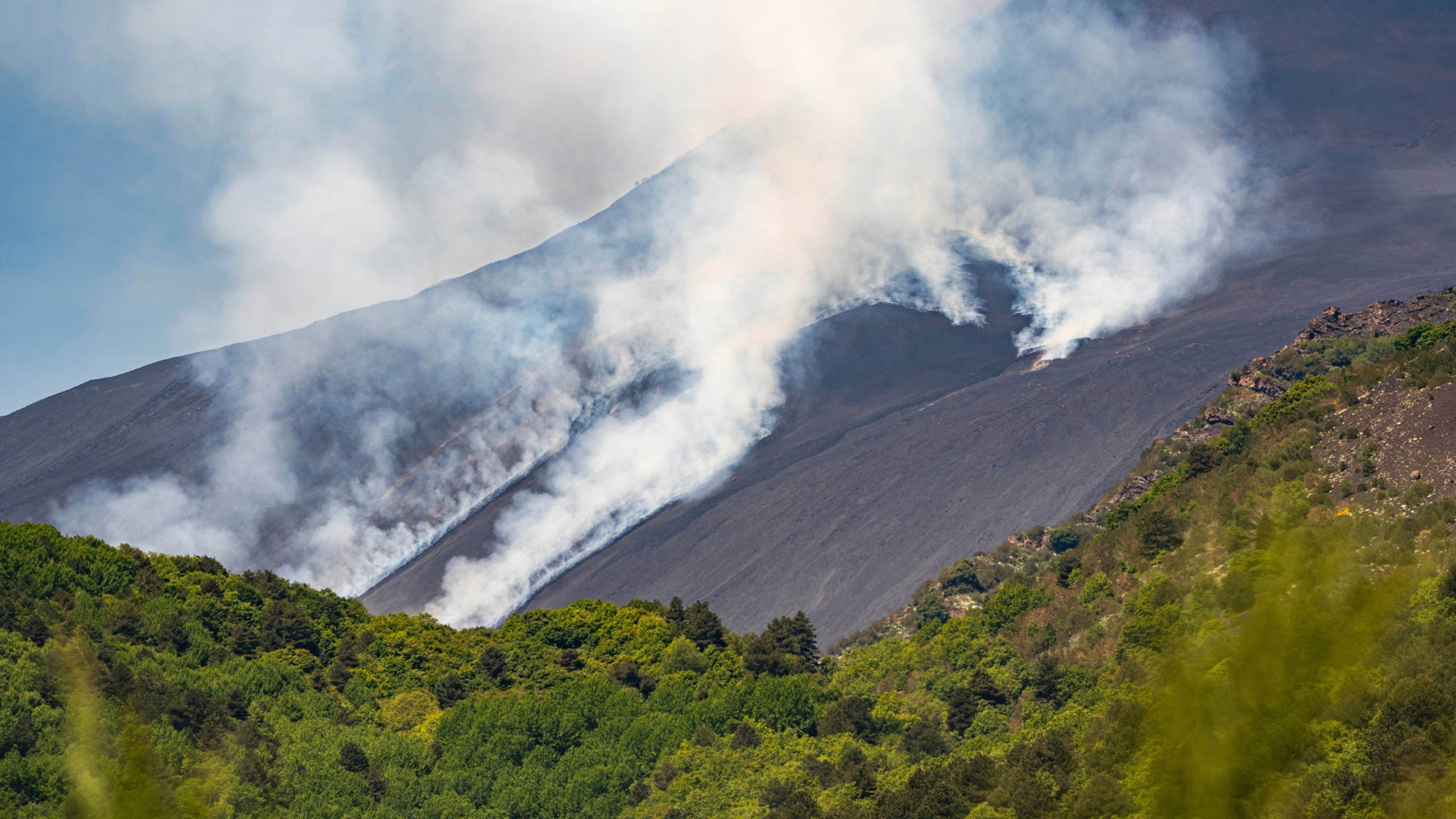 Smoke billows from Mount Etna volcano, Italy, Monday, June 2, 2025. (AP Photo/Giuseppe Distefano)