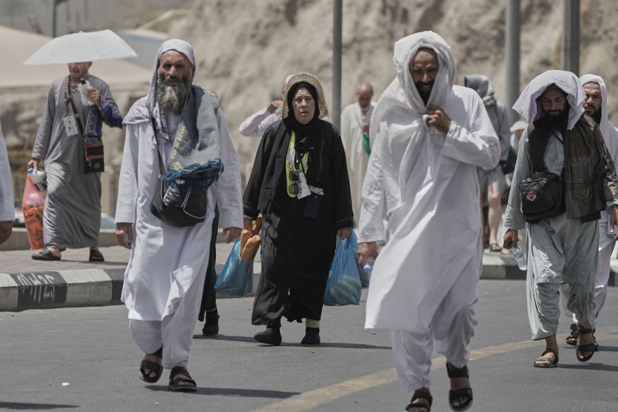 Muslim pilgrims prepare to enter the Grand Mosque, during the annual Hajj pilgrimage in Mecca, Saudi Arabia, Monday, June 2, 2025. (AP Photo/Amr Nabil)