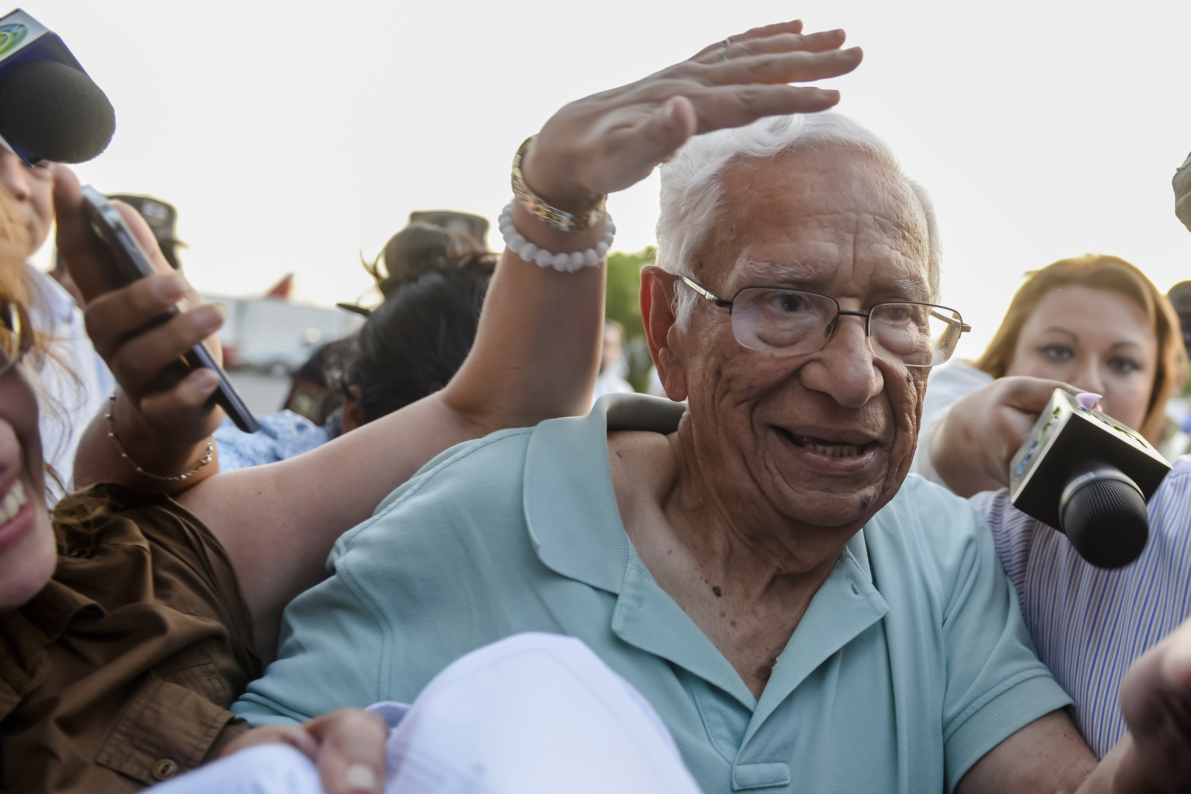 FILE - Former Defense Minister Jose Guillermo Garcia is surrounded by press as he arrives at the Oscar Arnulfo Romero international airport in San Luis Talpa, El Salvador, Jan. 8, 2016. (AP Photo/Salvador Melendez, File)