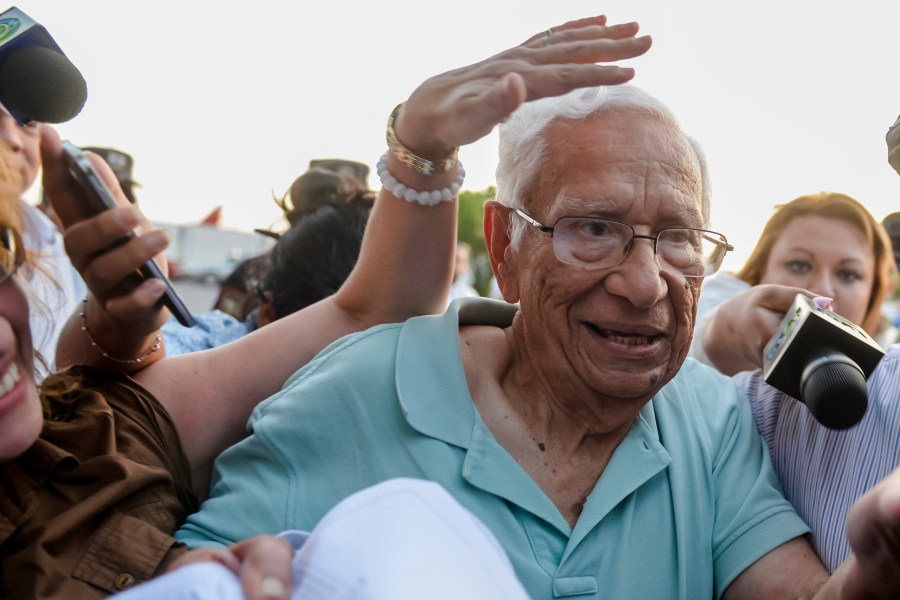 FILE - Former Defense Minister Jose Guillermo Garcia is surrounded by press as he arrives at the Oscar Arnulfo Romero international airport in San Luis Talpa, El Salvador, Jan. 8, 2016. (AP Photo/Salvador Melendez, File)