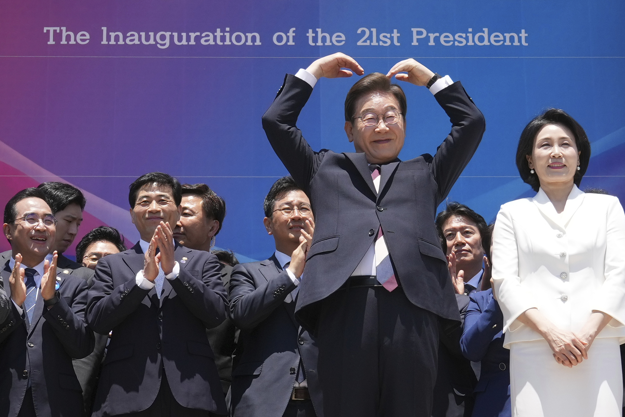 South Korean new President Lee Jae-myung, front left, and his wife Kim Hea Kyung greet to the people after attending the presidential inauguration at the National Assembly in Seoul, South Korea, Wednesday, June 4, 2025. (AP Photo/Lee Jin-man, Pool)