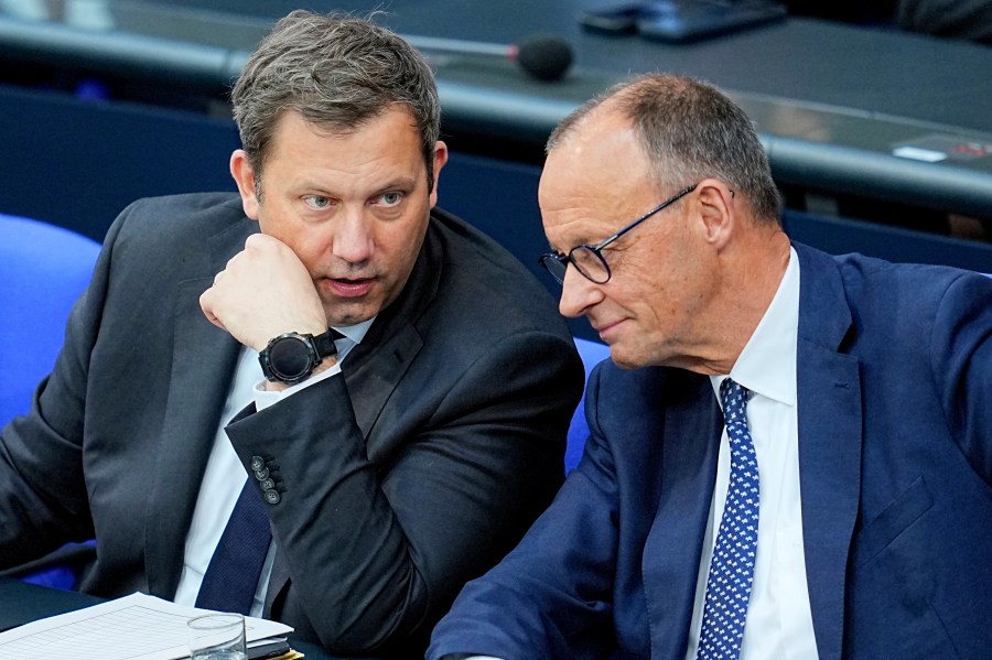 German Chancellor Friedrich Merz, right, and German Finance Minister Lars Klingbeil, left, talk during a meeting of the German parliament, Bundestag, at the Reichstag building in Berlin, Germany, Wednesday, May 14, 2025. (Michael Kappeler/dpa via AP)