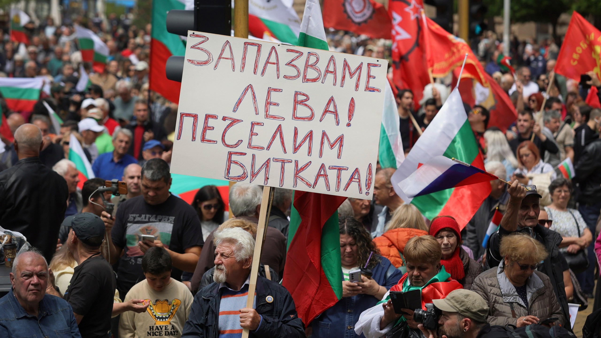 Protester holds a poster reading 'Preserve Bulgarian Lev. Win the battle!' during an anti-Euro protest in Sofia, Bulgaria Saturday 31, May 2025. (AP Photo/Valentina Petrova)