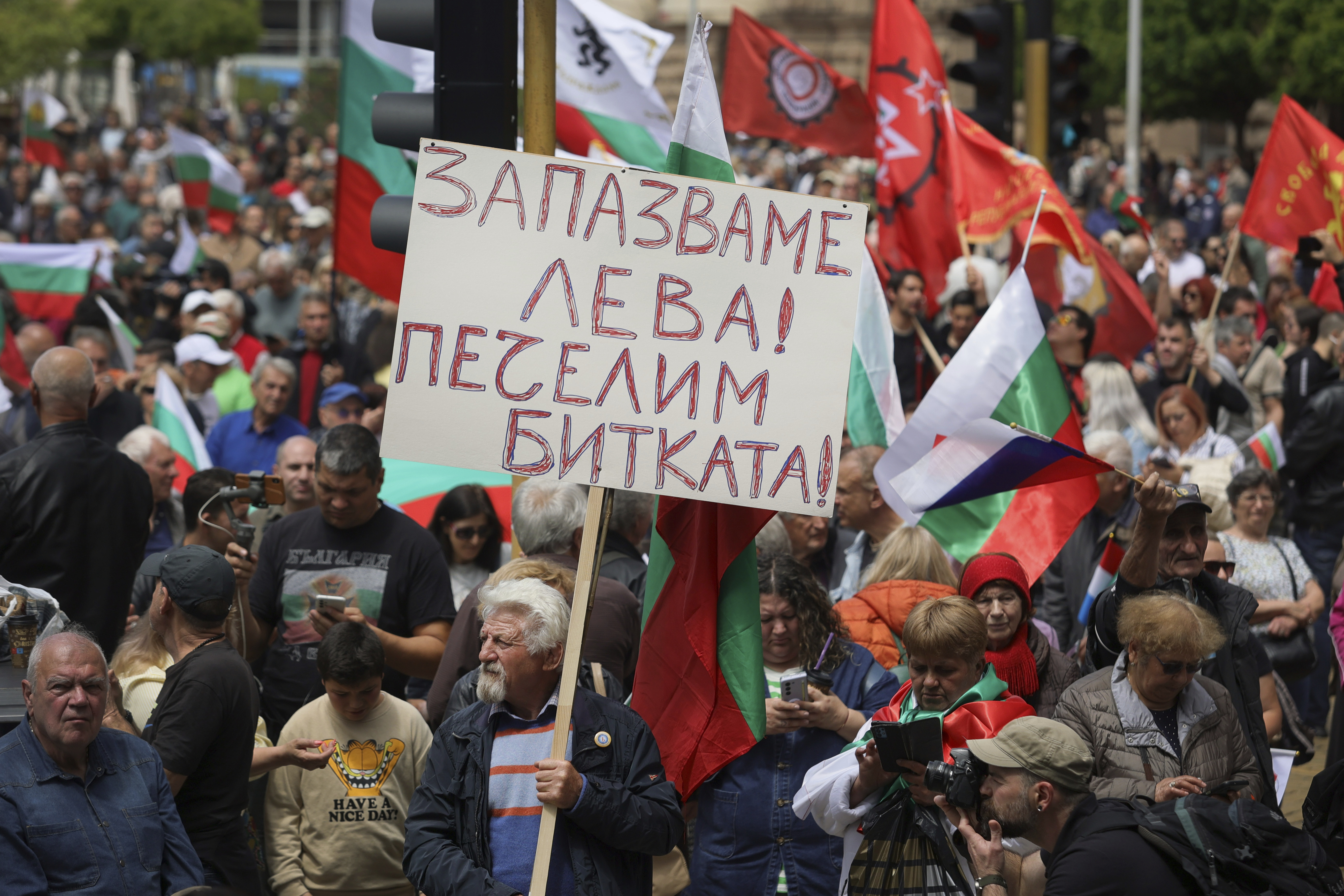 Protester holds a poster reading 'Preserve Bulgarian Lev. Win the battle!' during an anti-Euro protest in Sofia, Bulgaria Saturday 31, May 2025. (AP Photo/Valentina Petrova)