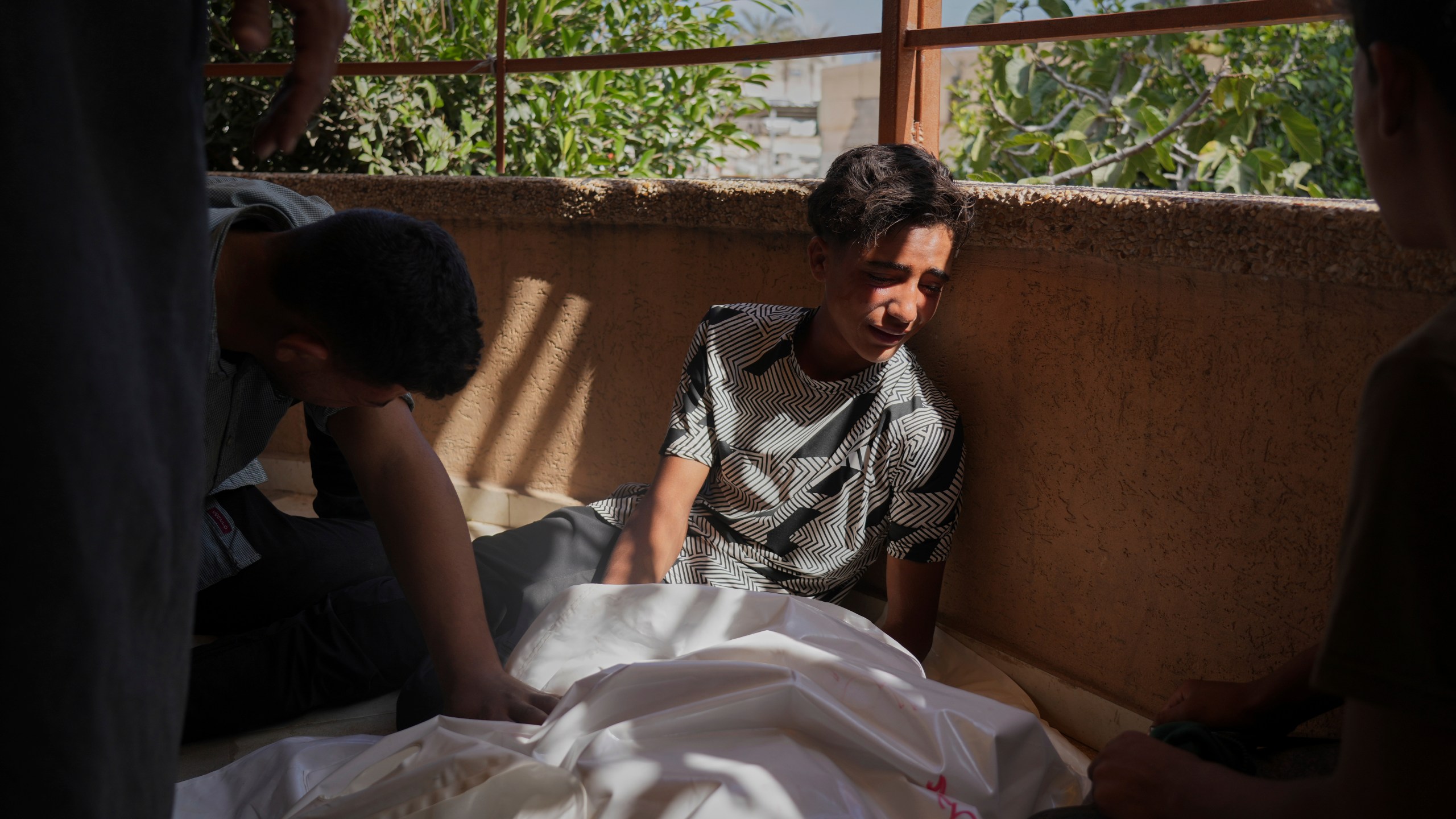 Palestinians mourn Abdul Rahman Al-Qudra, who was killed while heading to an aid distribution hub, in Khan Younis, Gaza Strip, Tuesday, June 3, 2025. (AP Photo/Abdel Kareem Hana)