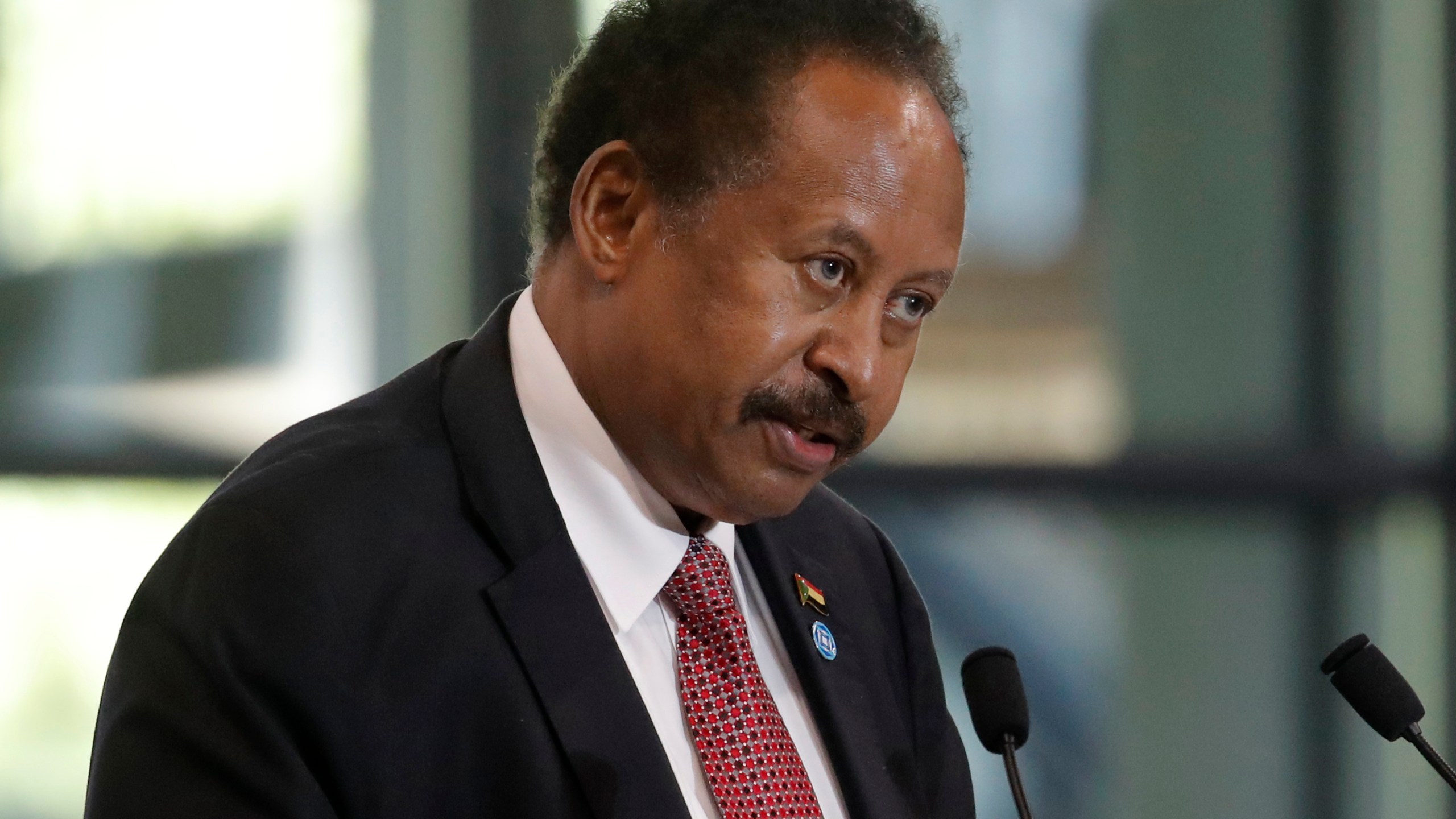 FILE - Sudanese Prime Minister Abdalla Hamdok speaks during a session of the summit to support Sudan, at the Grand Palais Ephemere in Paris on May 17, 2021. (AP Photo/Christophe Ena, Pool, File)