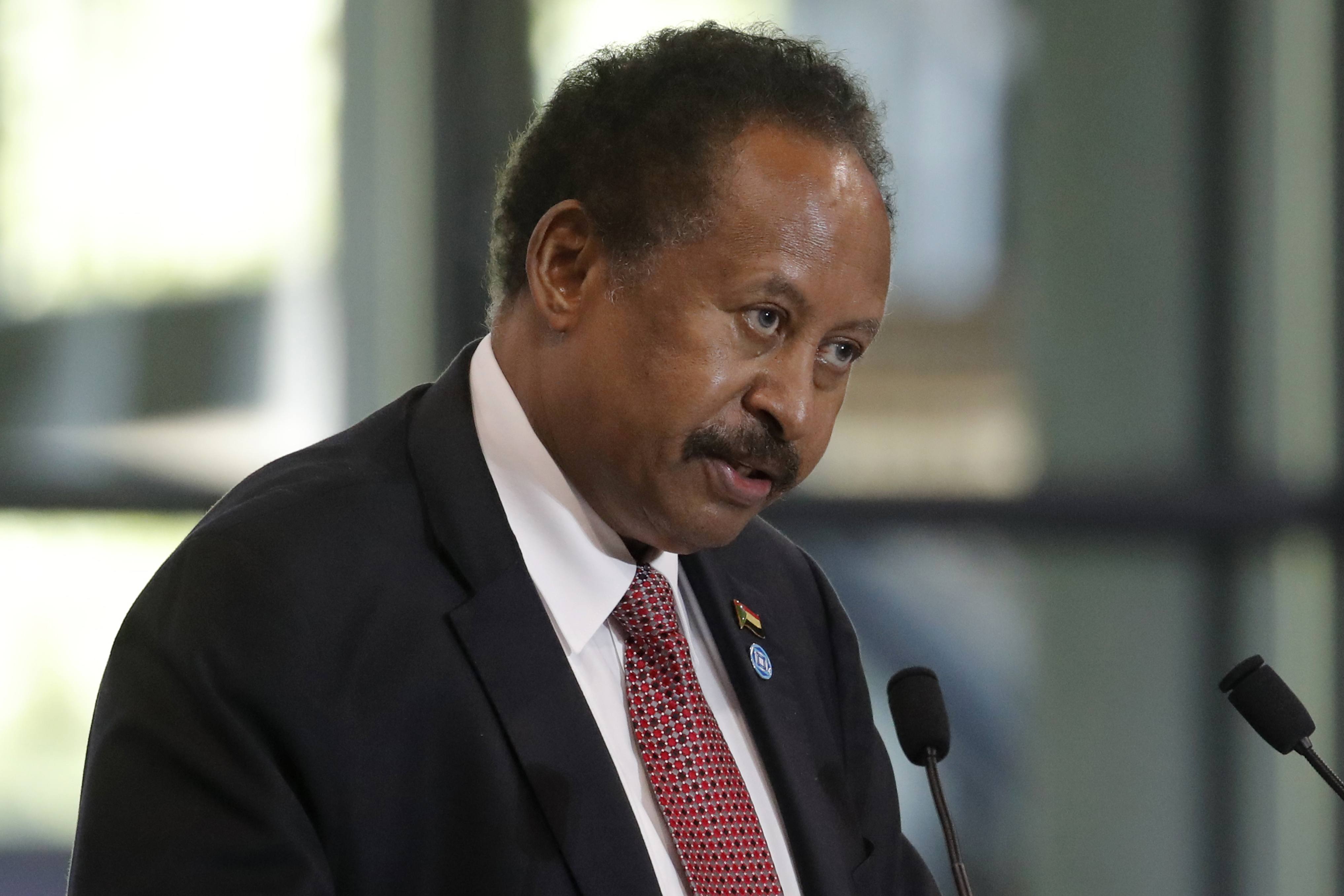 FILE - Sudanese Prime Minister Abdalla Hamdok speaks during a session of the summit to support Sudan, at the Grand Palais Ephemere in Paris on May 17, 2021. (AP Photo/Christophe Ena, Pool, File)