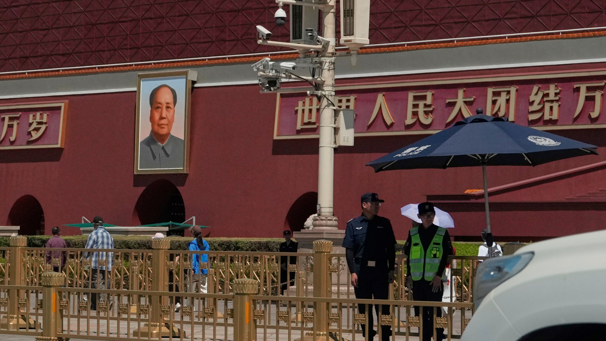 Security personnel stand on duty near the Tiananmen Gate which is under renovation on the anniversary of China's bloody 1989 crackdown on pro-democracy protests in Beijing, Wednesday, June 4, 2025. (AP Photo/Ng Han Guan)