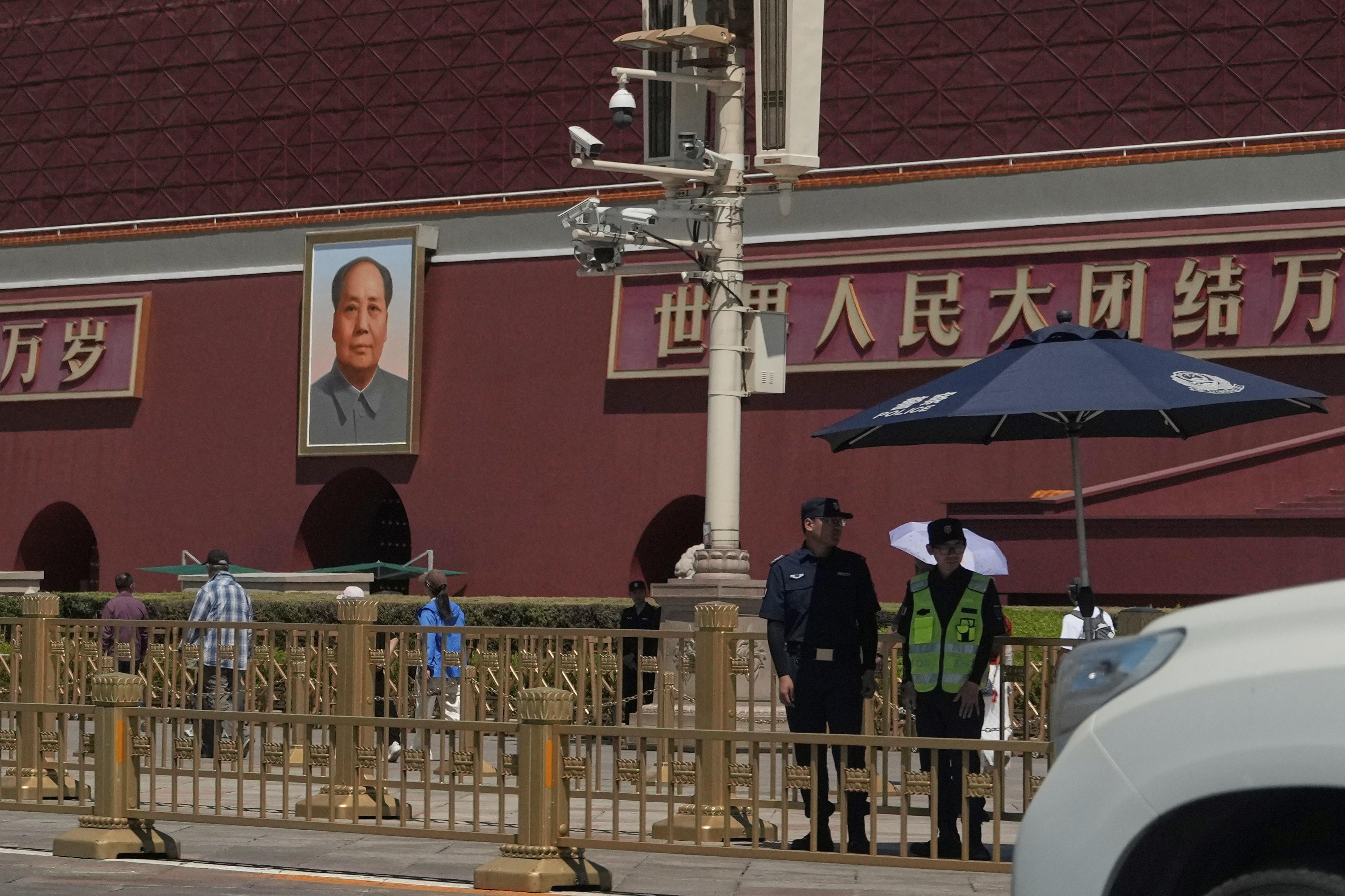 Security personnel stand on duty near the Tiananmen Gate which is under renovation on the anniversary of China's bloody 1989 crackdown on pro-democracy protests in Beijing, Wednesday, June 4, 2025. (AP Photo/Ng Han Guan)