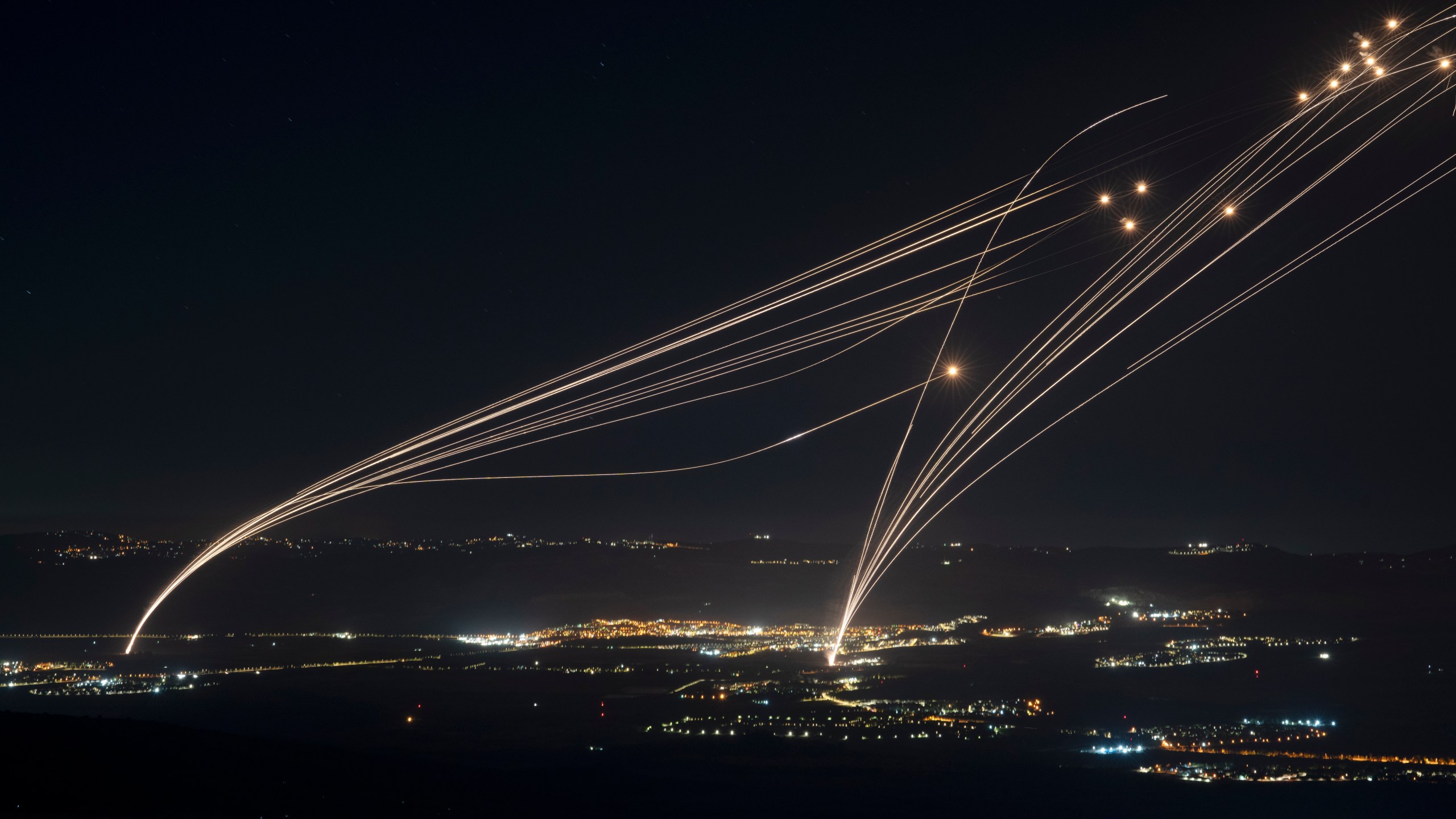 FILE - The Israeli Iron Dome air defense system fires to intercept an attack from Lebanon over the Galilee region as seen from the Israeli-annexed Golan Heights, Aug. 4, 2024. (AP Photo/Leo Correa, file)