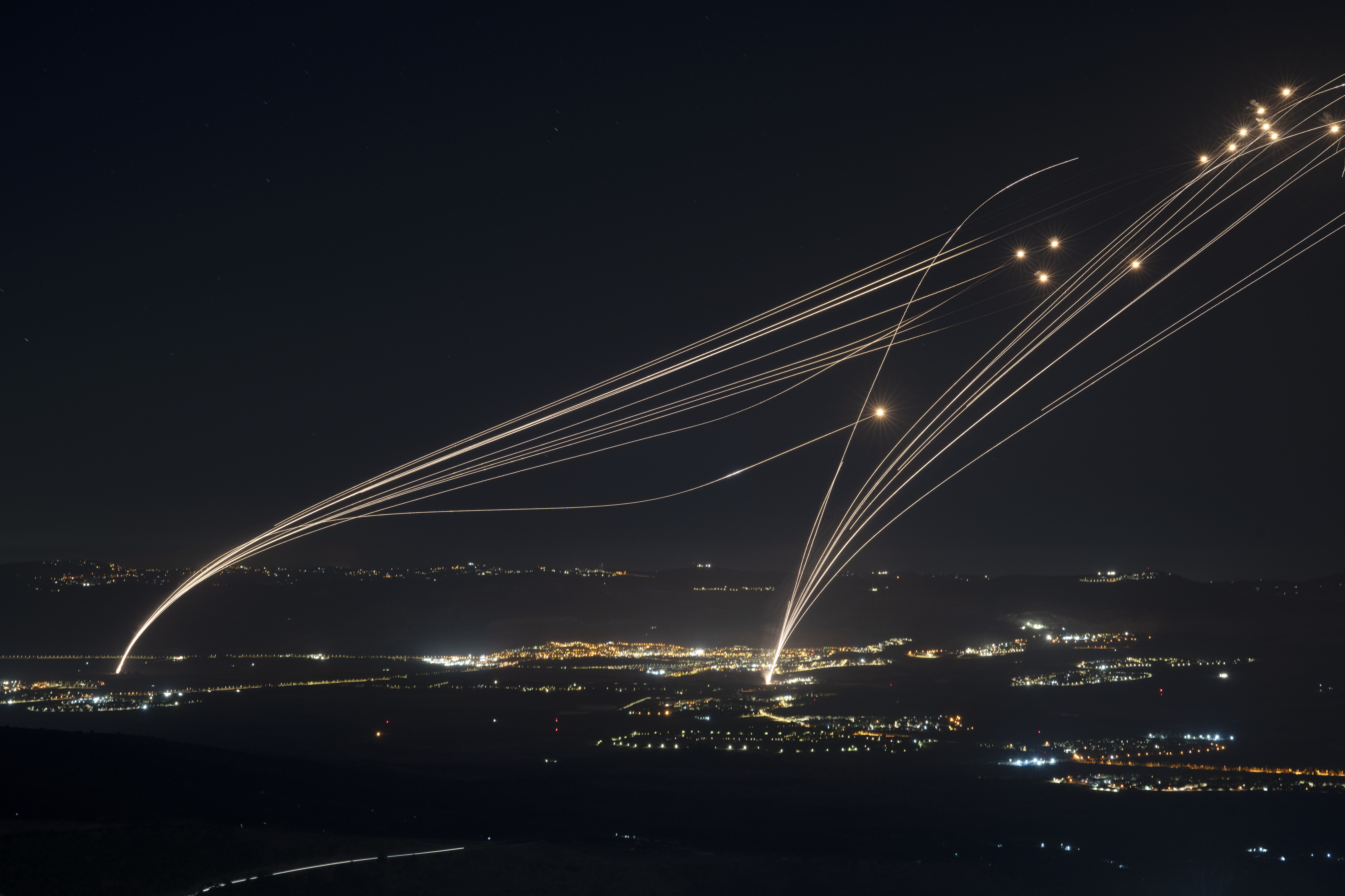 FILE - The Israeli Iron Dome air defense system fires to intercept an attack from Lebanon over the Galilee region as seen from the Israeli-annexed Golan Heights, Aug. 4, 2024. (AP Photo/Leo Correa, file)