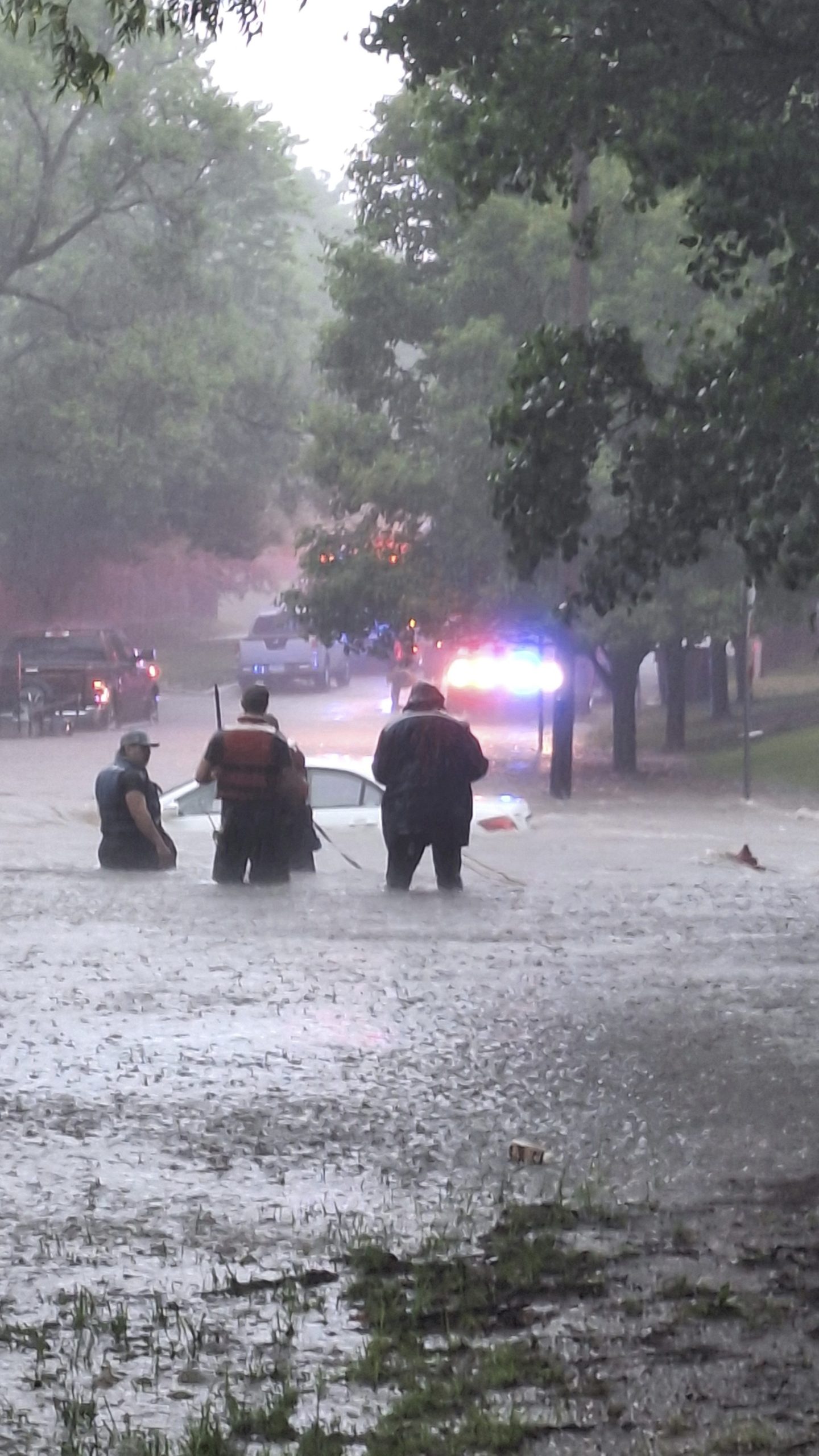 This photo provided by Colin Fee, a vehicle is surrounded by flood waters as heavy rains caused flash flooding in the Wichita area of south-central Kansas forcing firefighters to rescue dozens of people, including stranded motorists on Tuesday, June 3, 2025. (Colin Fee via AP)