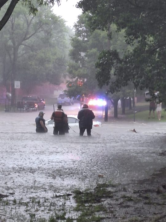 This photo provided by Colin Fee, a vehicle is surrounded by flood waters as heavy rains caused flash flooding in the Wichita area of south-central Kansas forcing firefighters to rescue dozens of people, including stranded motorists on Tuesday, June 3, 2025. (Colin Fee via AP)