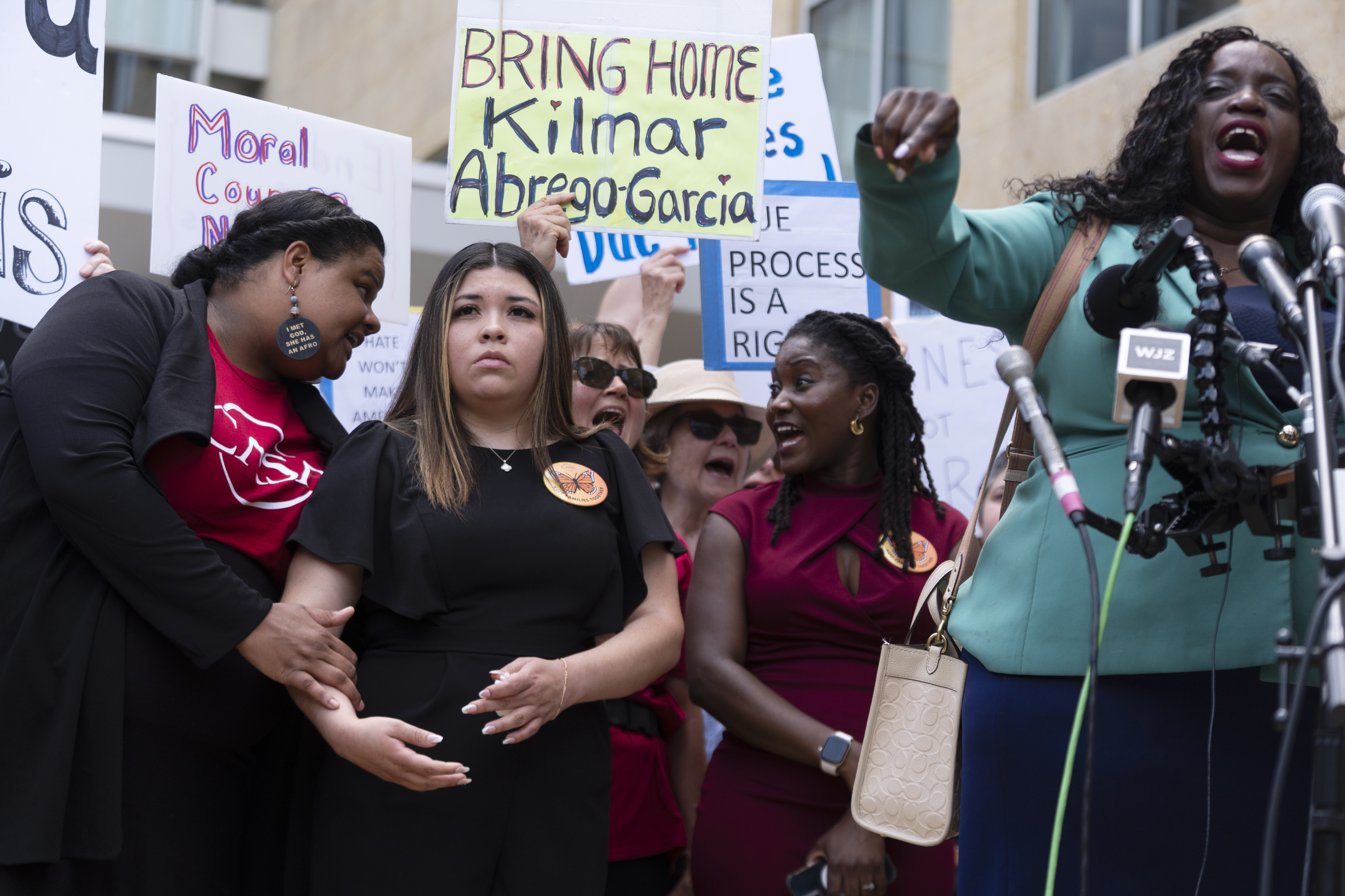 Wife of Kilmar Abrego Garcia, Jennifer Vasquez Sura, second from left, joins a rally outside the U.S. Courthouse in Greenbelt, Md., where a federal judge in Maryland will hear arguments Friday, May 16, 2025. (AP Photo/Manuel Balce Ceneta)
