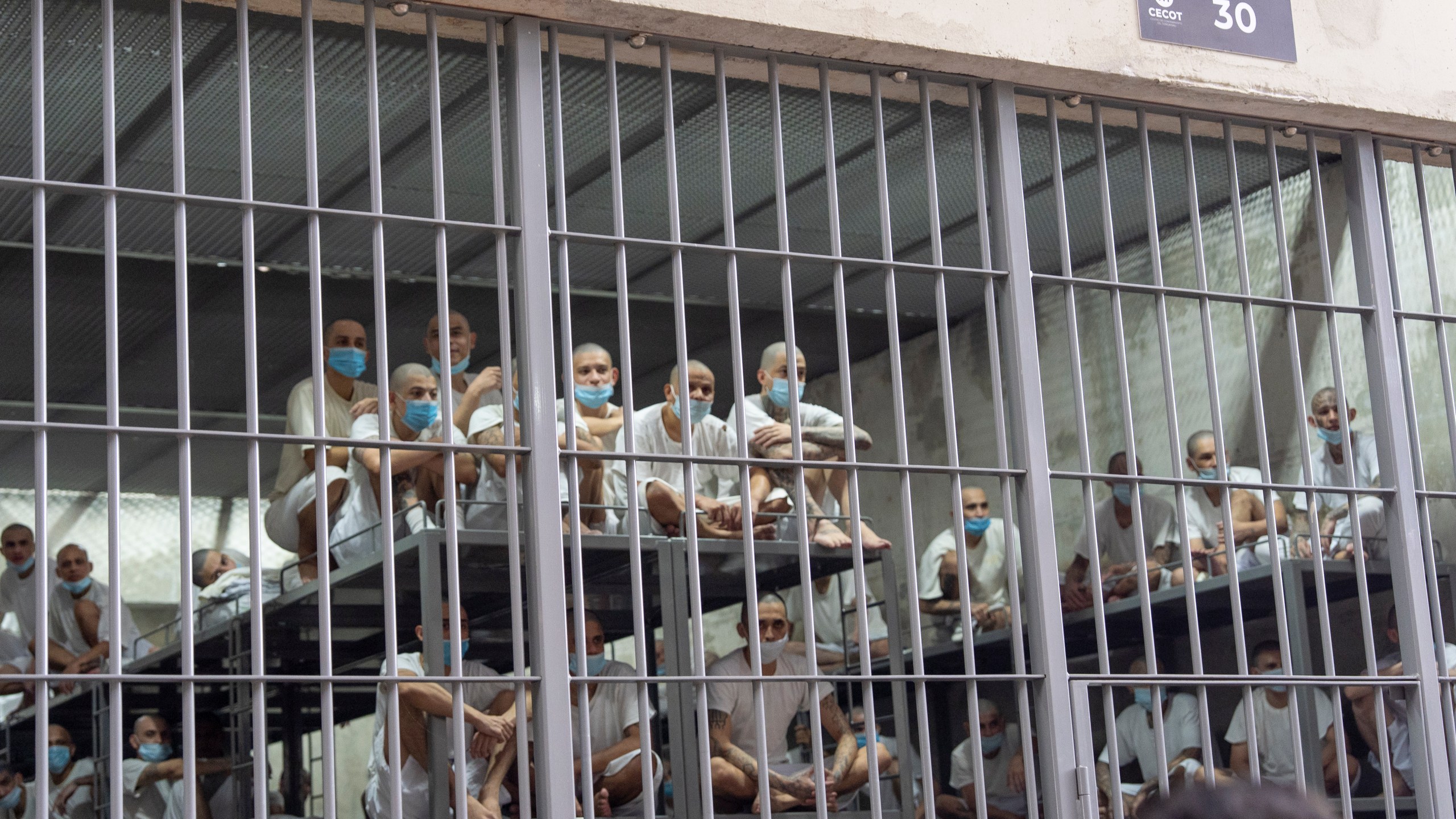 FILE - Prisoners look out of their cell as Homeland Security Secretary Kristi Noem tours the Terrorist Confinement Center in Tecoluca, El Salvador, March 26, 2025. (AP Photo/Alex Brandon, File)