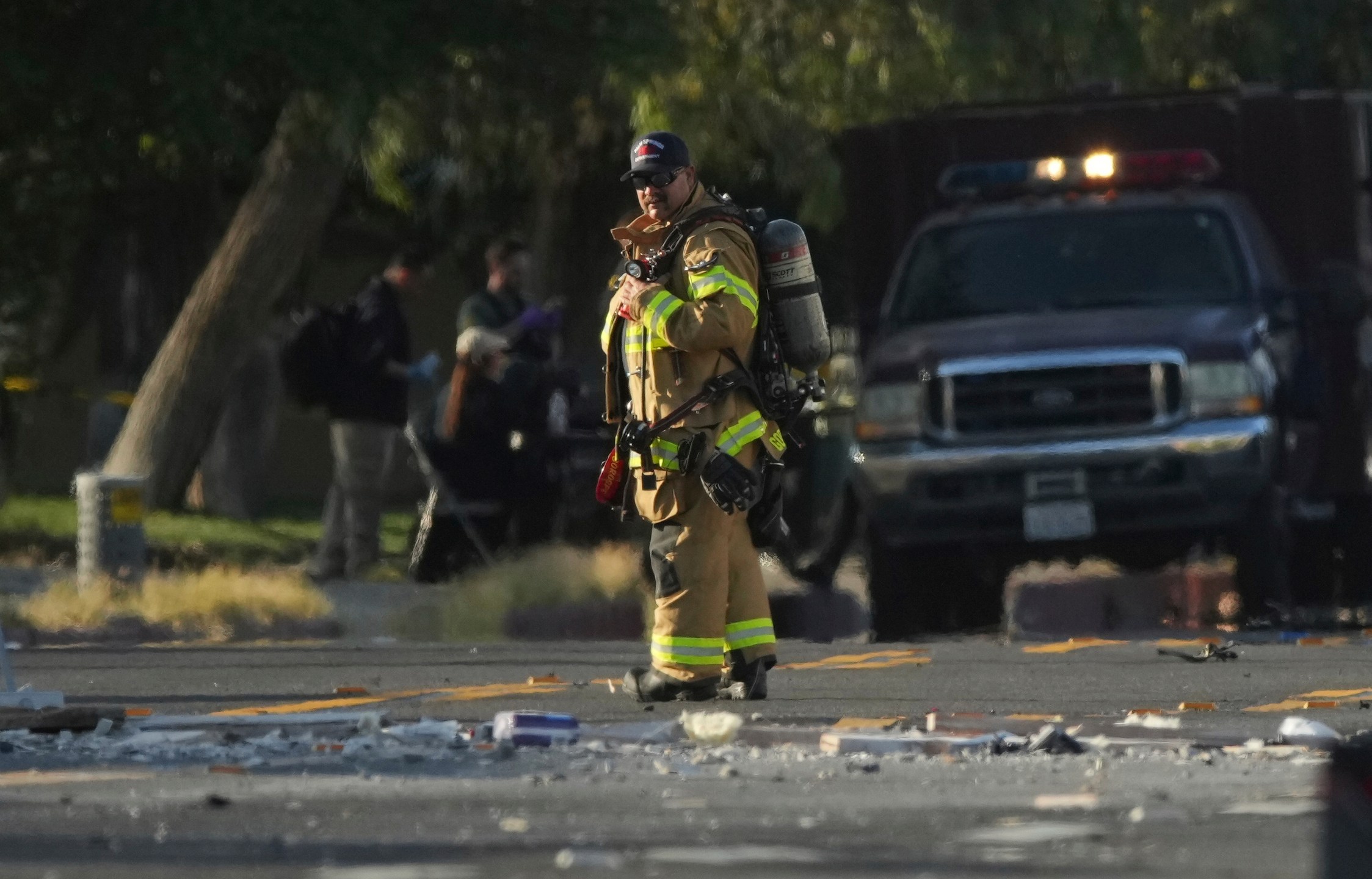 A firefighter stands at the scene of an explosion in Palm Springs, Calif., on Saturday, May 17, 2025. (AP Photo/Eric Thayer)