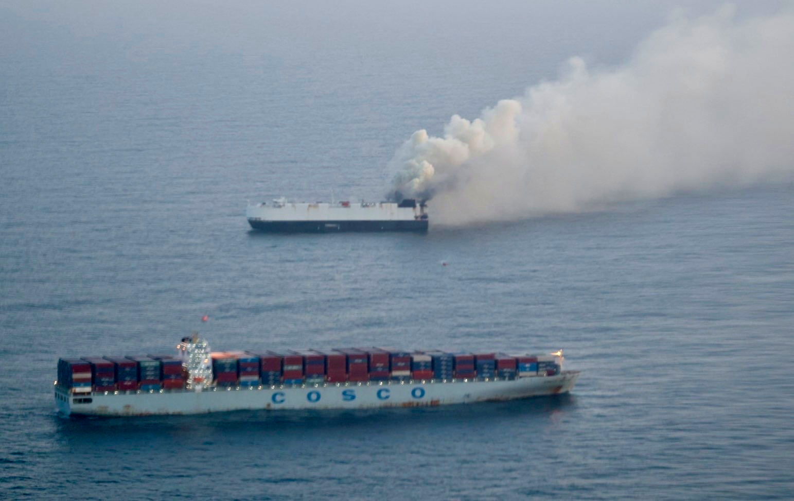In this photo provided by the U.S. Coast Guard, smoke rises from cargo vessel Morning Midas approximately 300 miles south of Adak, Alaska, June 3, 2025, as the crew of a cargo ship carrying about 3,000 vehicles to Mexico, abandoned ship after they could not control a fire. (U.S. Coast Guard/Courtesy of Air Station Kodiak via AP)