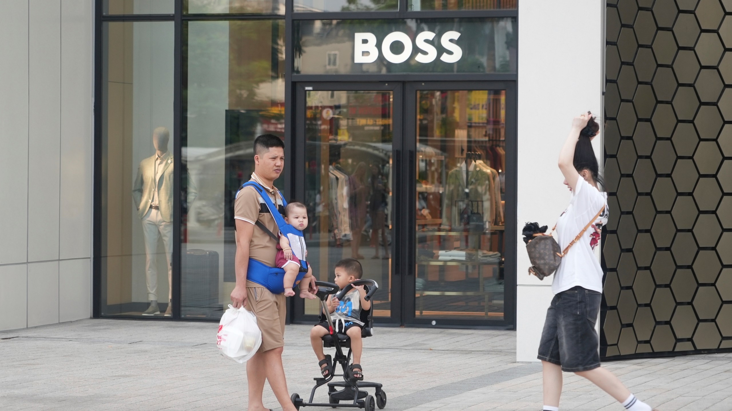 A family shopping at a shopping mall in Hanoi, Vietnam, Wednesday, June 4, 2025. (AP Photo/Hau Dinh)
