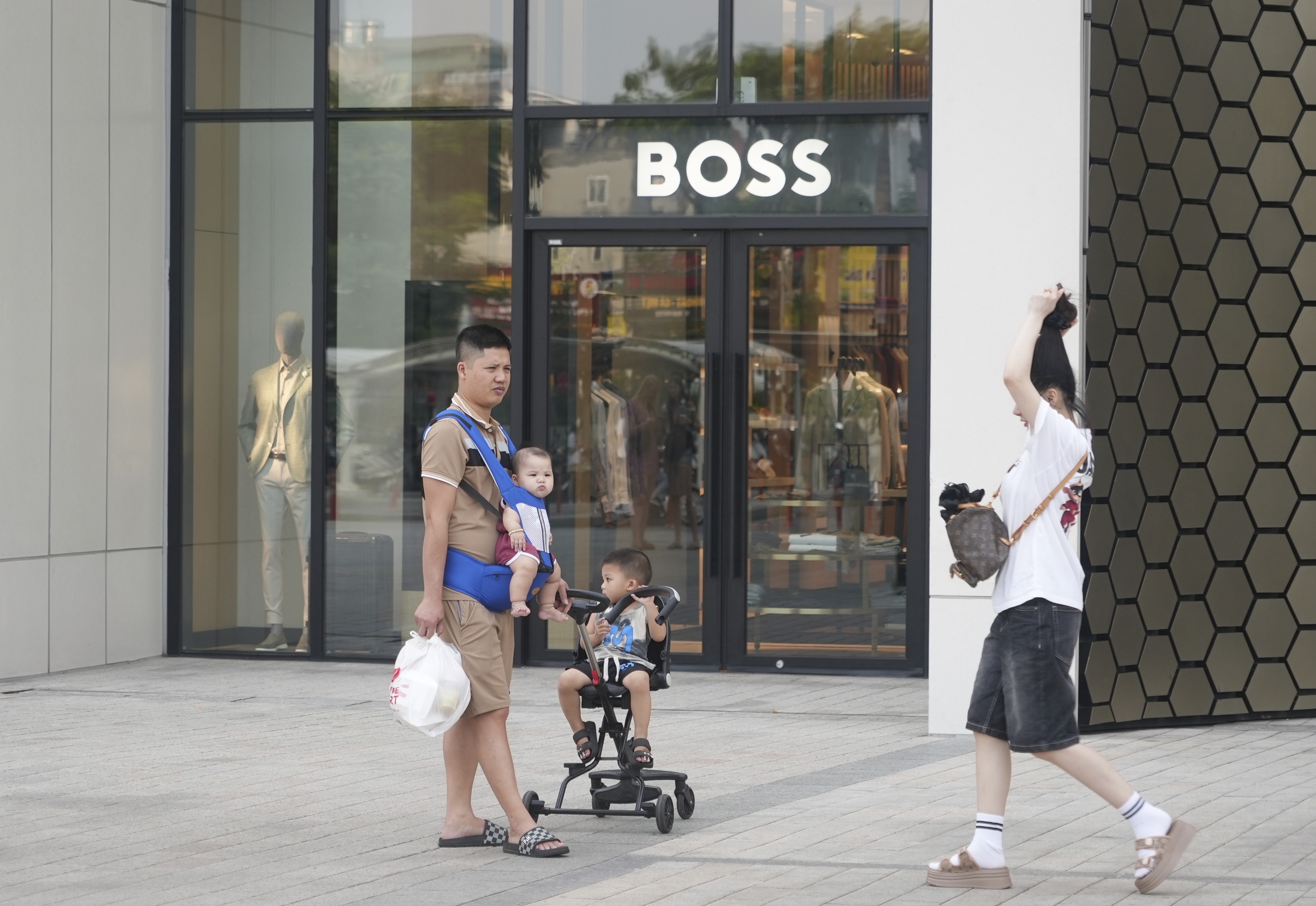 A family shopping at a shopping mall in Hanoi, Vietnam, Wednesday, June 4, 2025. (AP Photo/Hau Dinh)