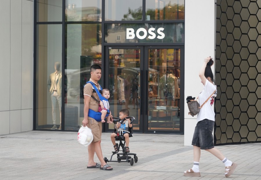 A family shopping at a shopping mall in Hanoi, Vietnam, Wednesday, June 4, 2025. (AP Photo/Hau Dinh)