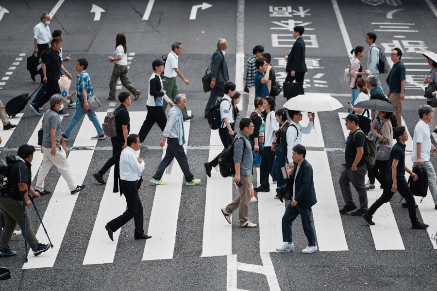 People walk along a pedestrian crossing at a shopping street Wednesday, June 4, 2025, in Tokyo. (AP Photo/Eugene Hoshiko)