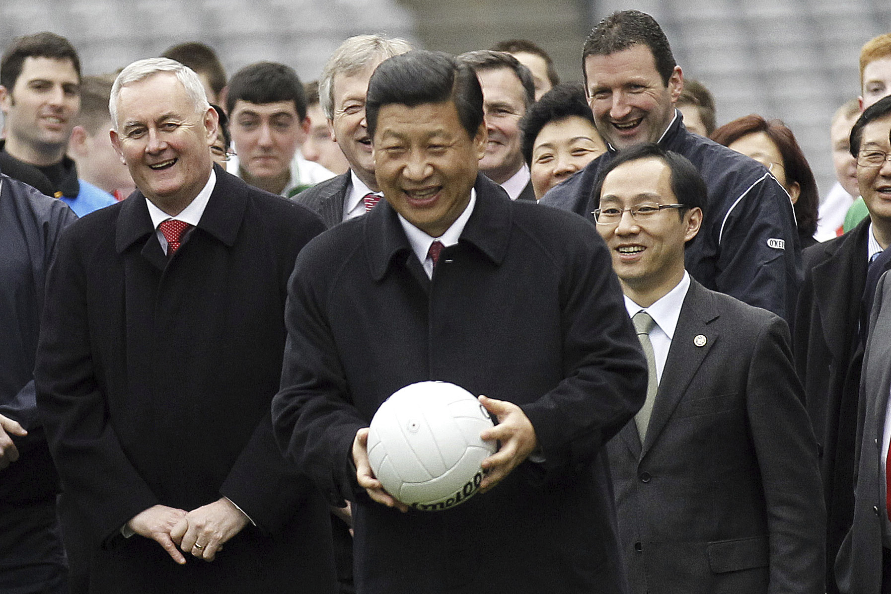 FILE - Then Vice President Xi Jinping of the People's Republic of China prepares to kick a Gaelic football during a visit to Croke Park Stadium, Ireland, on Feb. 19, 2012. (AP Photo/Peter Morrison, File)