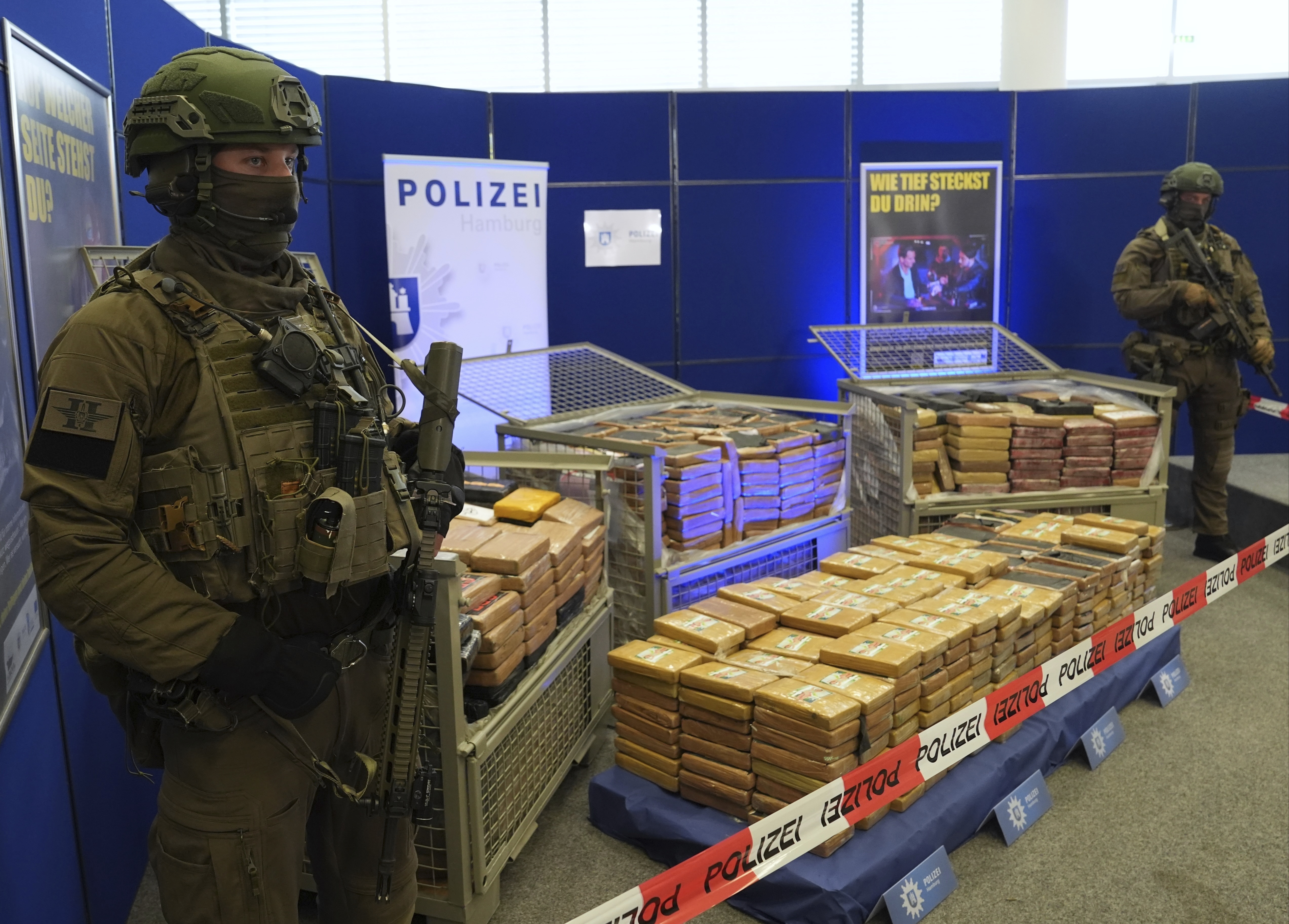 Special police force officers secure packages of seized cocaine as they are presented to a news conference at police headquarters in Hamburg, Sept. 27, 2024. (Marcus Brandt/dpa via AP)