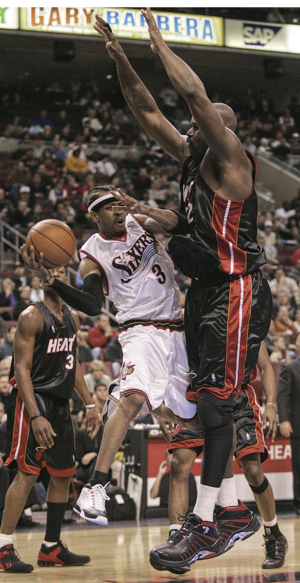 FILE - Miami Heat's Shaquille O'Neal, right, defends against Philadelphia 76ers' Allen Iverson (3) in the first half on Jan. 24, 2005, in Philadelphia. (AP Photo/Miles Kennedy, File)