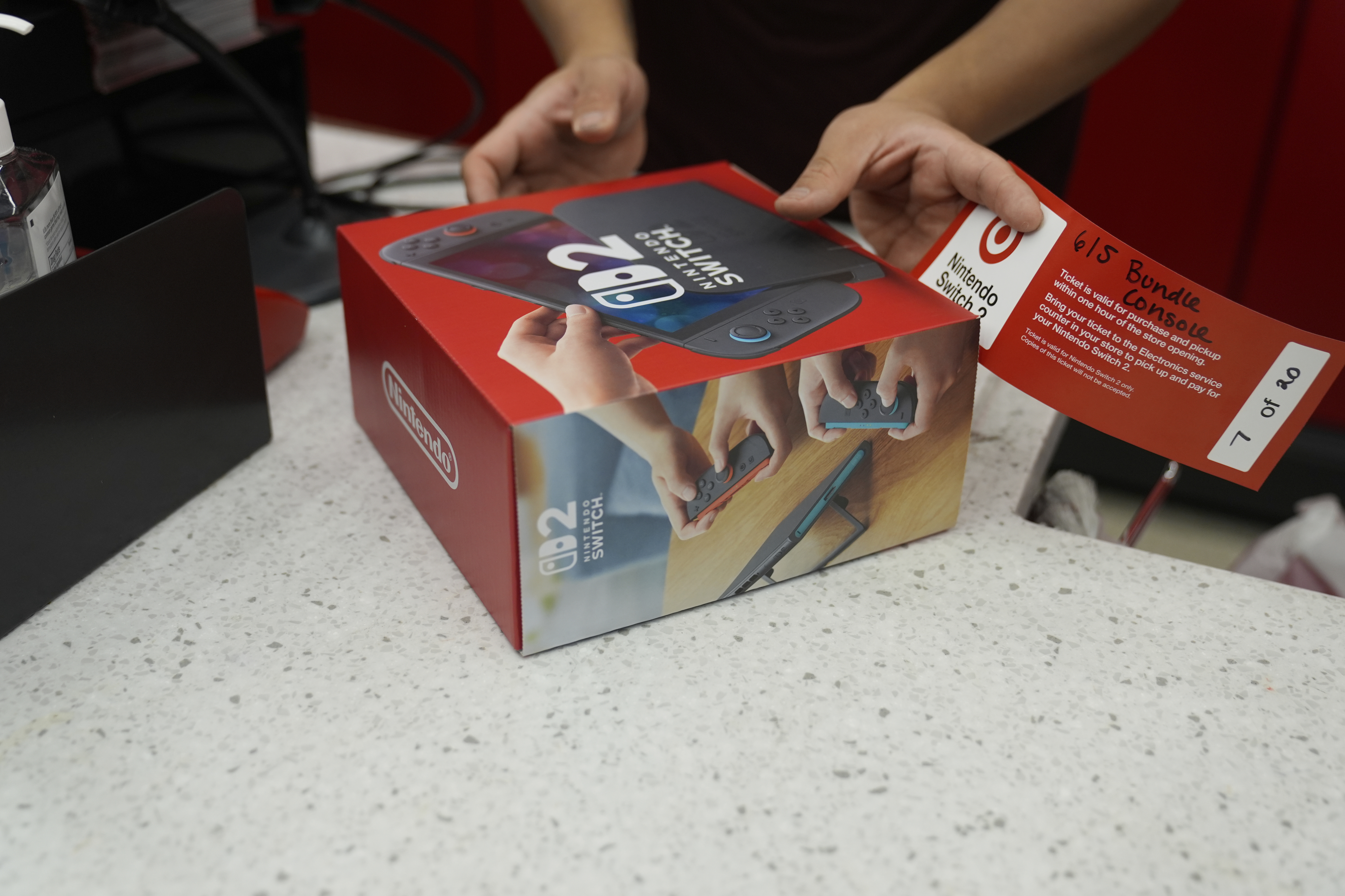 A customer receives the new Nintendo Switch 2 video game console at a Target store on Thursday, June 5, 2025 in Chicago. (AP Photo/Kiichiro Sato)
