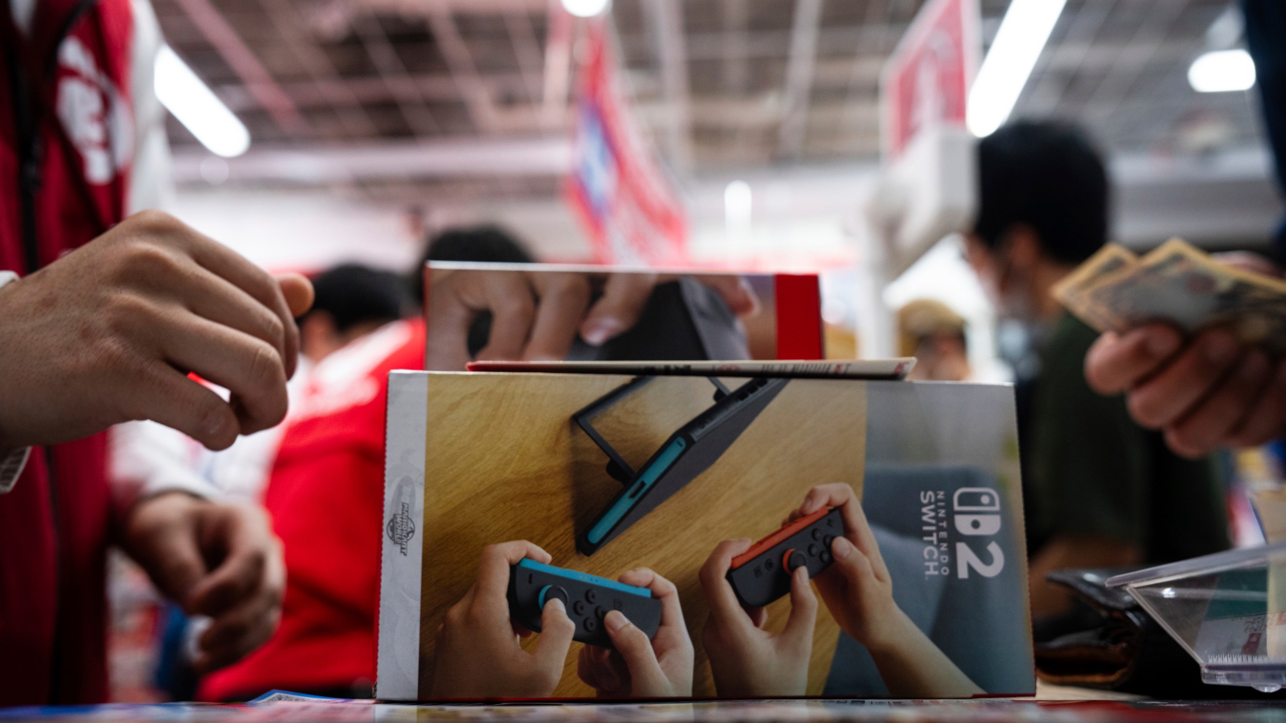 A customer purchases Nintendo Switch 2 at an electronics retailer in Tokyo, Thursday, June 5, 2025. (AP Photo/Louise Delmotte)