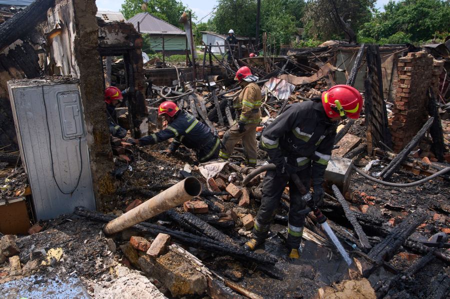 Rescue workers extinguish a fire of a house destroyed by a Russian drone strike in Pryluky village, Ukraine, Thursday, June 5, 2025. (AP Photo/Evgeniy Maloletka)