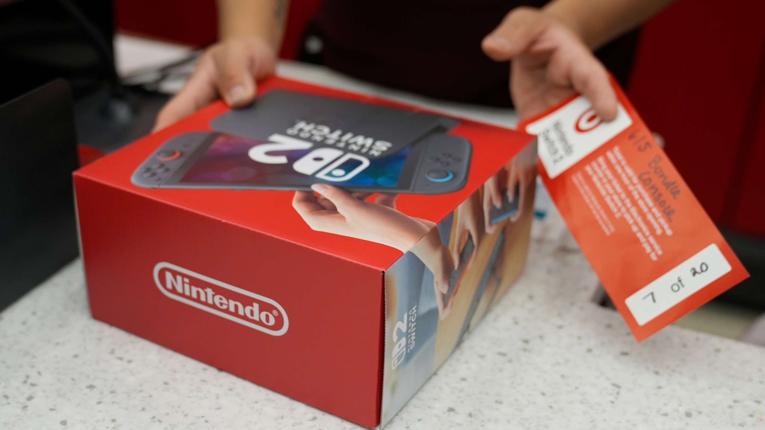 A customer receives the new Nintendo Switch 2 video game console at a Target store on Thursday, June 5, 2025 in Chicago. (AP Photo/Kiichiro Sato)