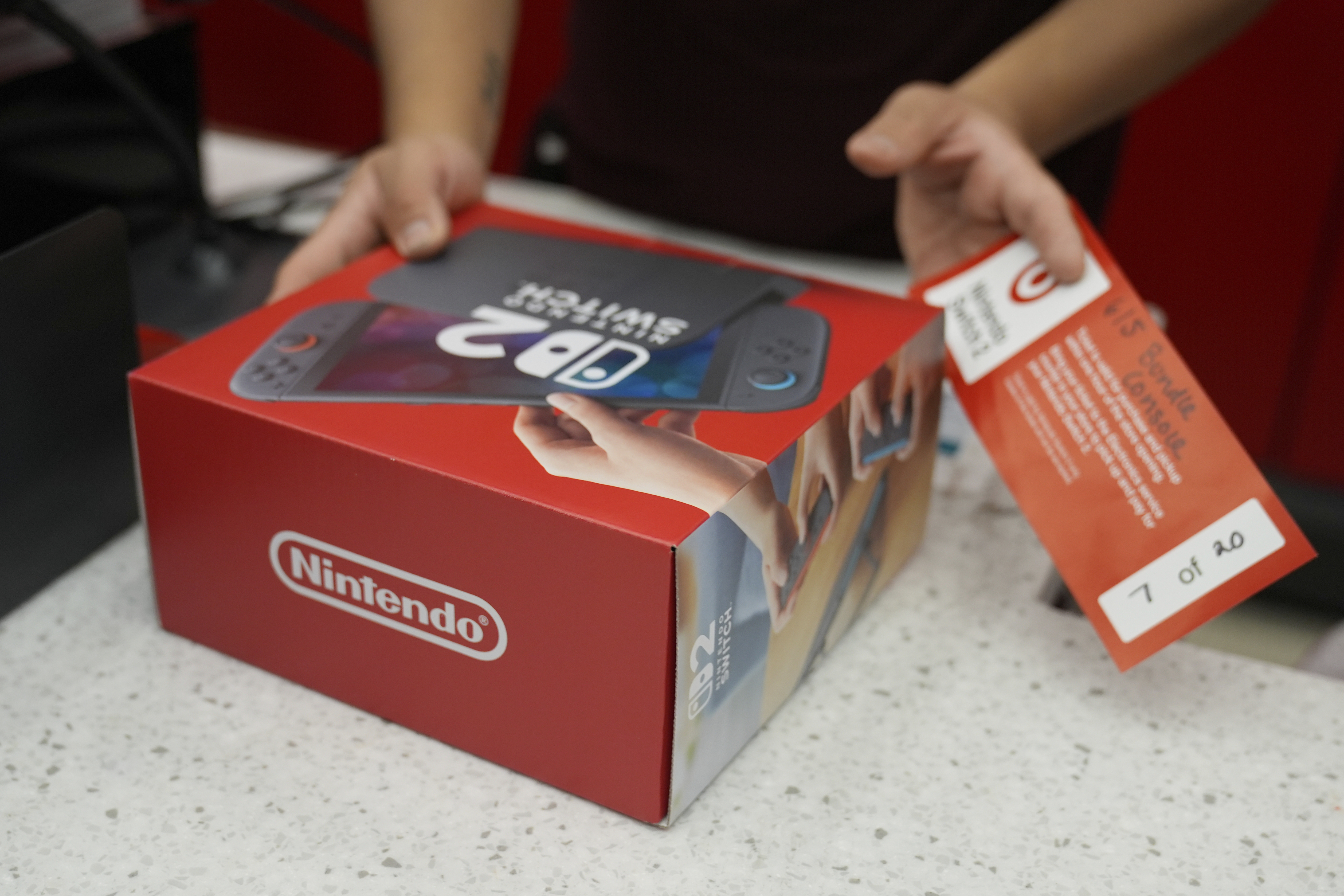A customer receives the new Nintendo Switch 2 video game console at a Target store on Thursday, June 5, 2025 in Chicago. (AP Photo/Kiichiro Sato)