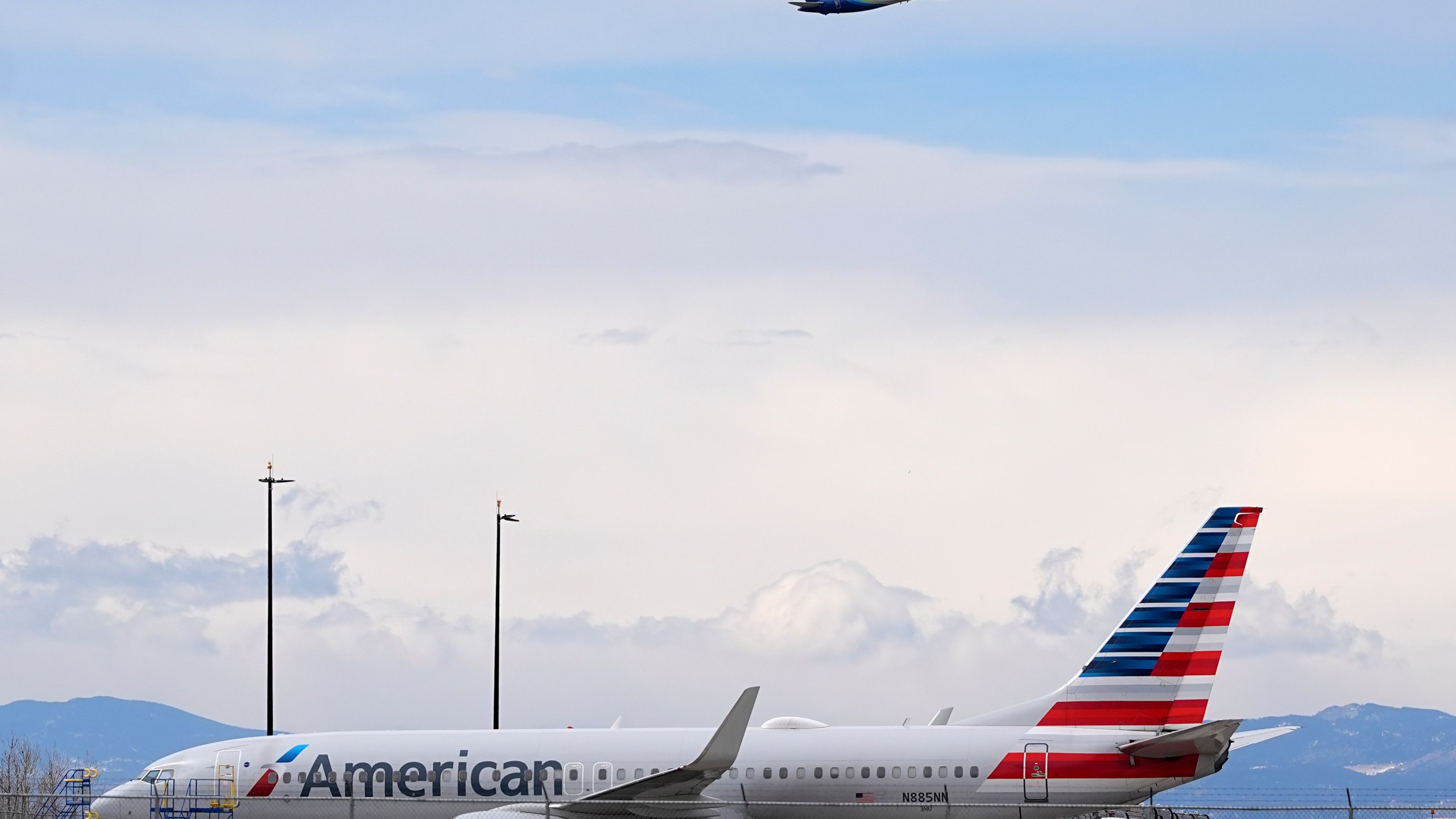 FILE - An American Airlines jetliner that caught fire after landing the previous day at Denver International Airport sits near a hangar at the airport, March 14, 2025, in Denver. (AP Photo/David Zalubowski, File)