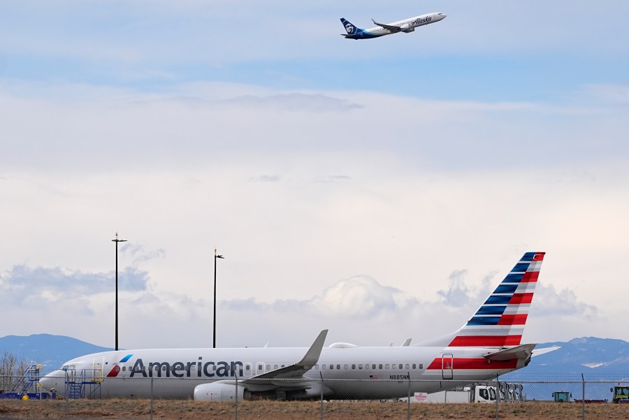 FILE - An American Airlines jetliner that caught fire after landing the previous day at Denver International Airport sits near a hangar at the airport, March 14, 2025, in Denver. (AP Photo/David Zalubowski, File)