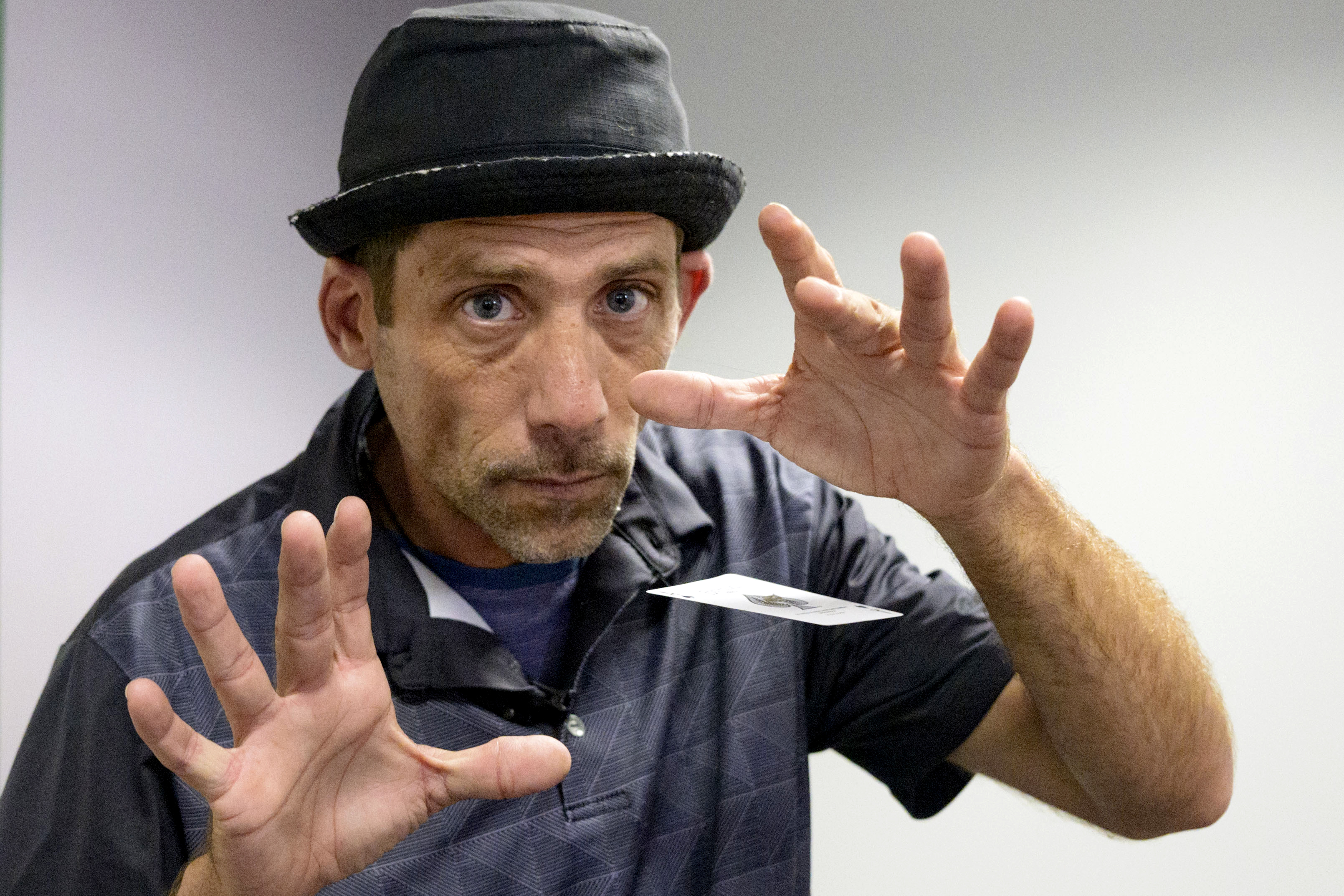 FILE - Paul Carpenter, a New Orleans magician, performs card tricks during an interview in New Orleans, Feb. 23, 2024. (AP Photo/Matthew Hinton, File)