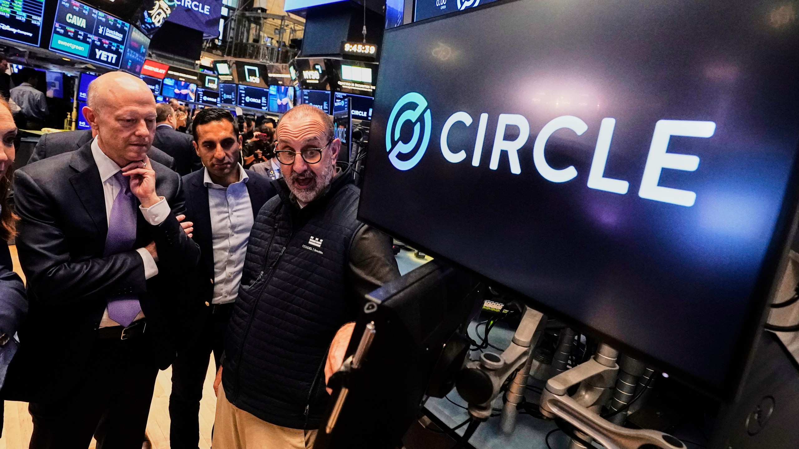 Jeremy Allaire, , left, Co-Founder, Chairman & CEO of Circle, listens to specialist Peter Giacchi, right, before the IPO opens, on the floor of the New York Stock Exchange, Thursday, June 5, 2025. (AP Photo/Richard Drew)