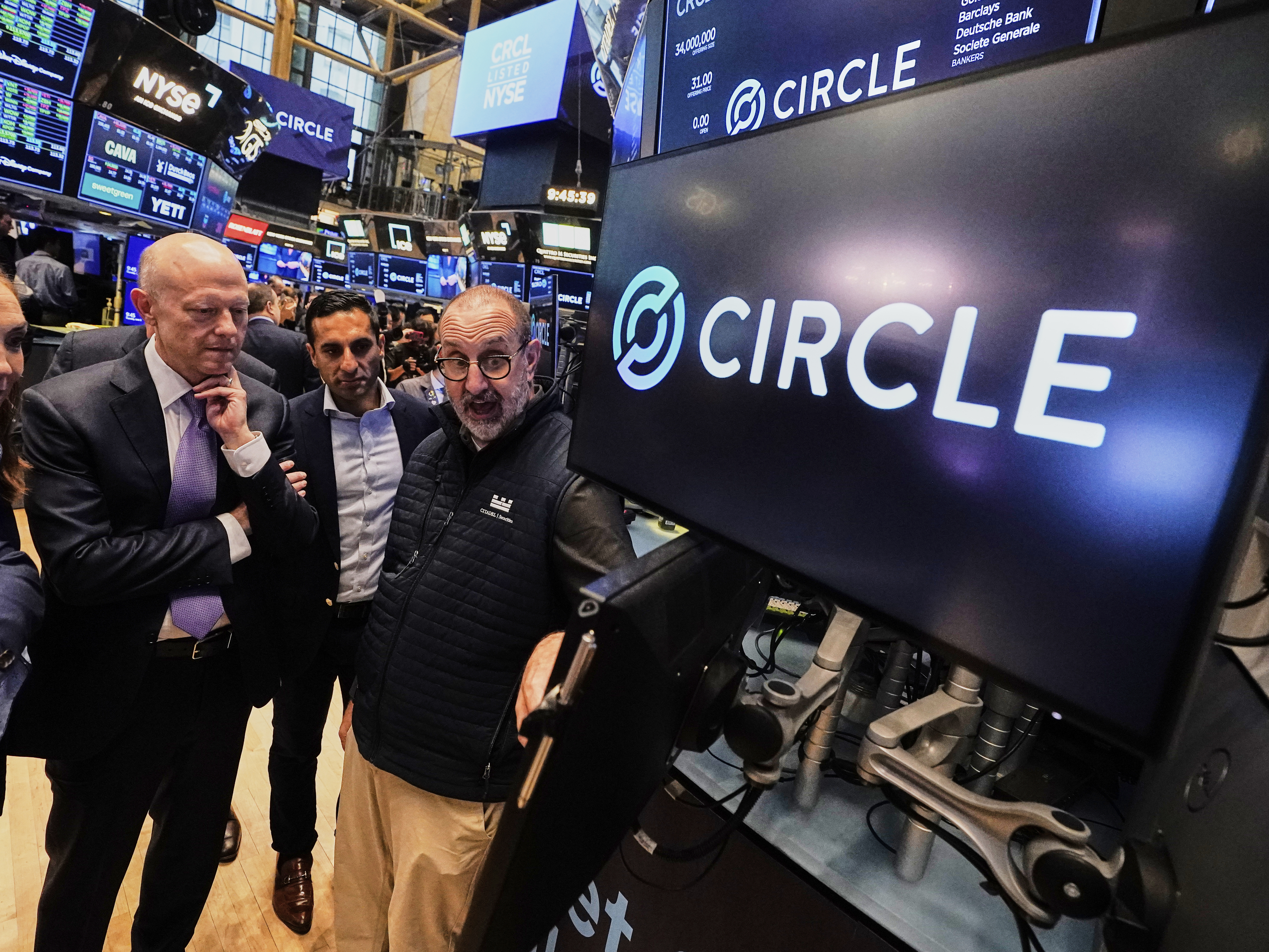 Jeremy Allaire, , left, Co-Founder, Chairman & CEO of Circle, listens to specialist Peter Giacchi, right, before the IPO opens, on the floor of the New York Stock Exchange, Thursday, June 5, 2025. (AP Photo/Richard Drew)