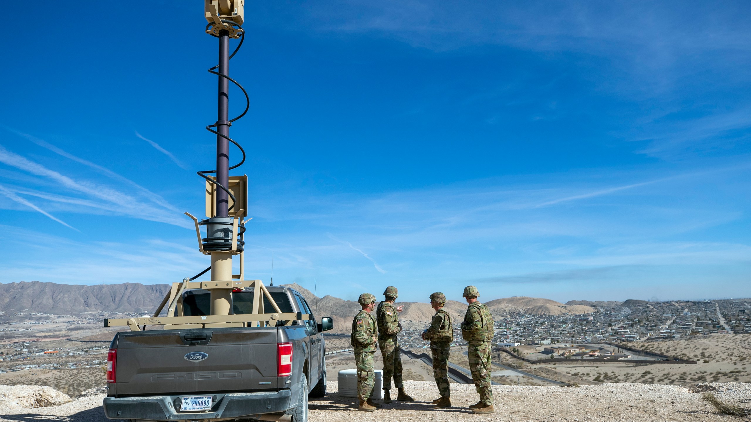 FILE - Army soldiers look at the border wall next to a surveillance vehicle in Sunland Park, N.M., Feb. 3, 2025. (AP Photo/Andres Leighton, File)
