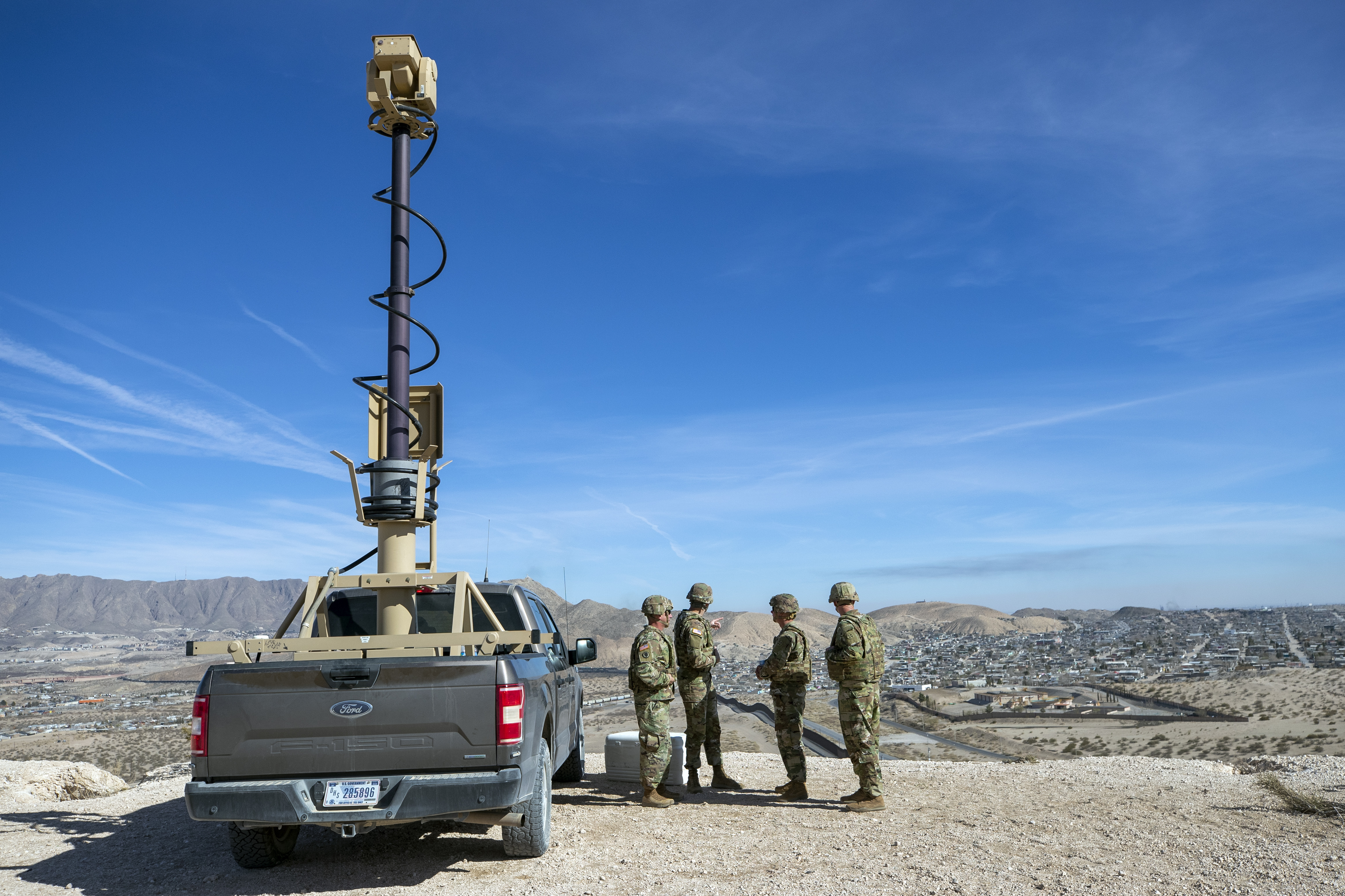 FILE - Army soldiers look at the border wall next to a surveillance vehicle in Sunland Park, N.M., Feb. 3, 2025. (AP Photo/Andres Leighton, File)
