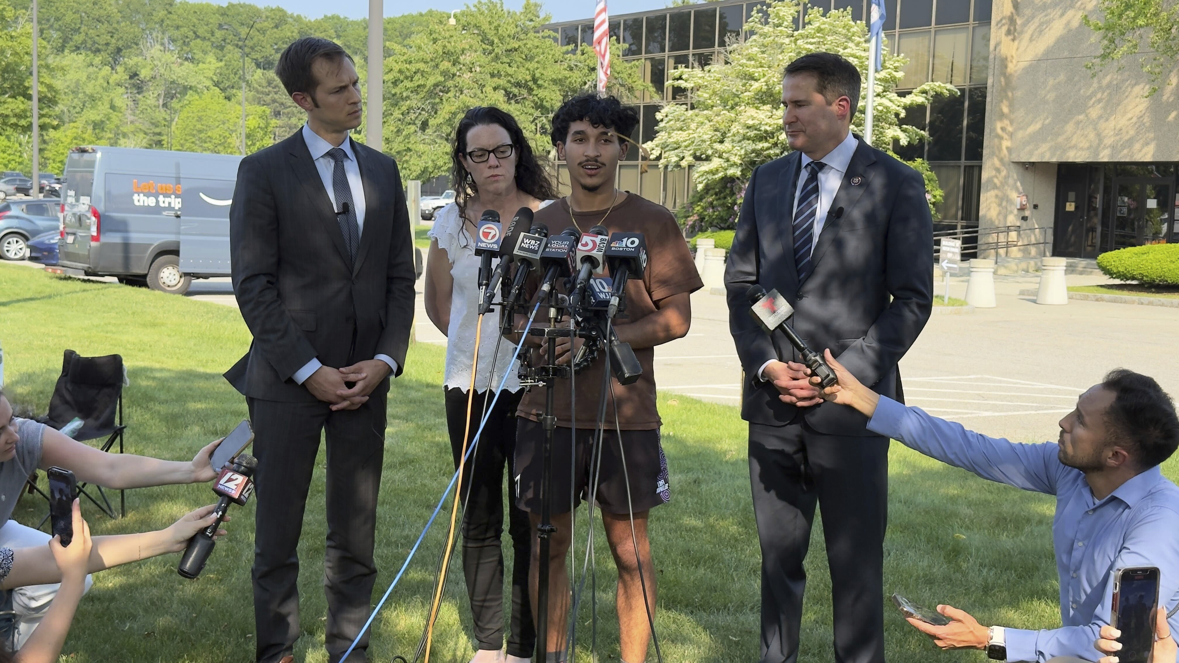 Marcelo Gomes da Silva, 18, center, a Massachusetts high school student who came to the U.S. from Brazil at age 7 and was detained by U.S. Immigration and Customs Enforcement agents Saturday, May 31, 2025, speaks to journalists after being released from detention on bond as Reps. Seth Moulton, D-Mass., right, and Jake Auchincloss, D-Mass., left, listen, Thursday, June 5, 2025, in Burlington, Mass. (AP Photo/Rodrique Ngowi)