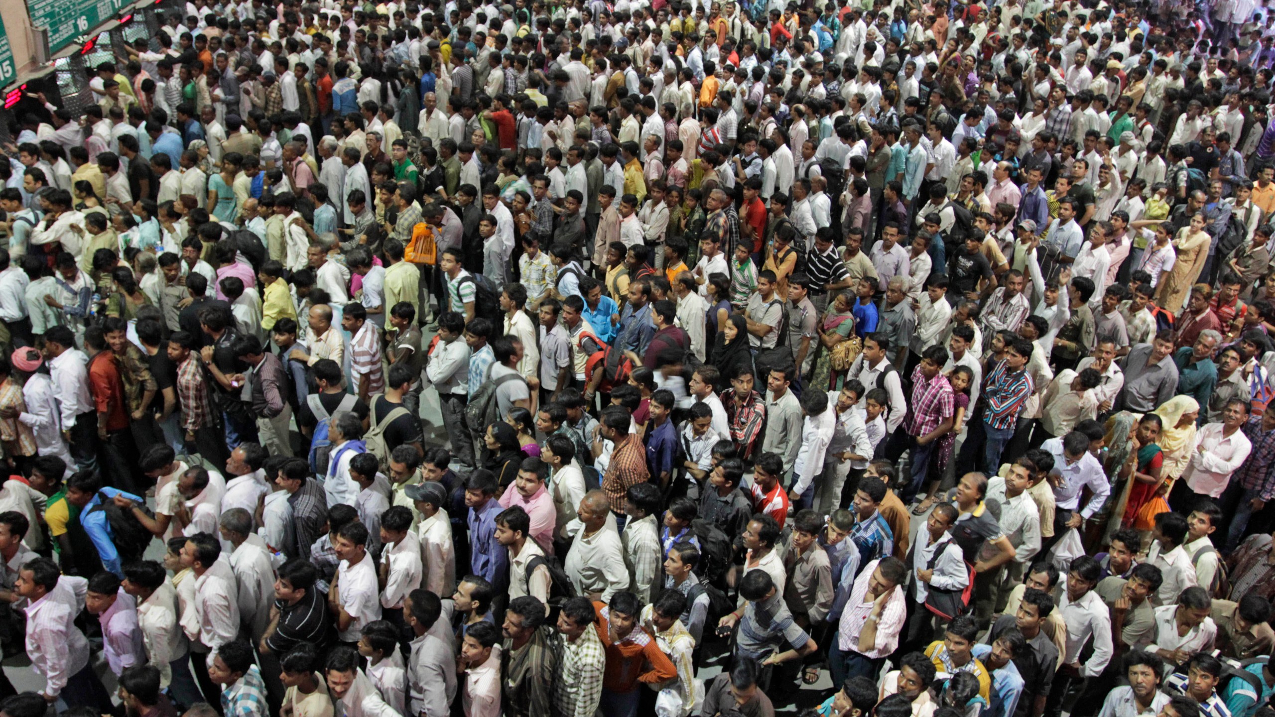 FILE - Indians crowd ticket counters at a railway station in Ahmadabad, India, Oct. 23, 2011. (AP Photo/Ajit Solanki, File)