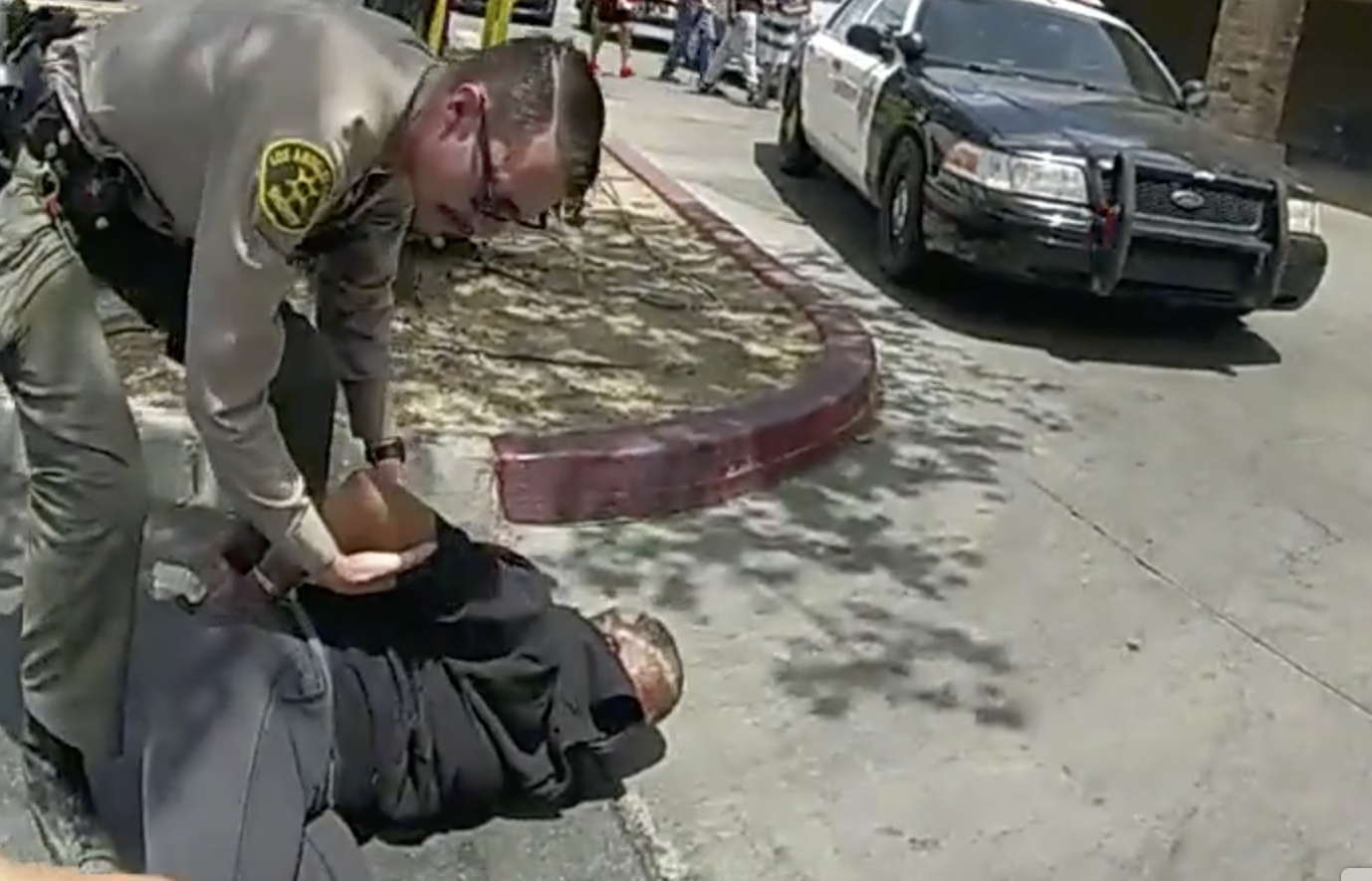 FILE - In this image taken from police body camera footage provided by Los Angeles Sheriff's office, a Sheriff's deputies arrests a couple in a grocery store parking lot in Lancaster, Calif., on June 24, 2023. (Los Angeles County Sheriff's Office via AP, File)